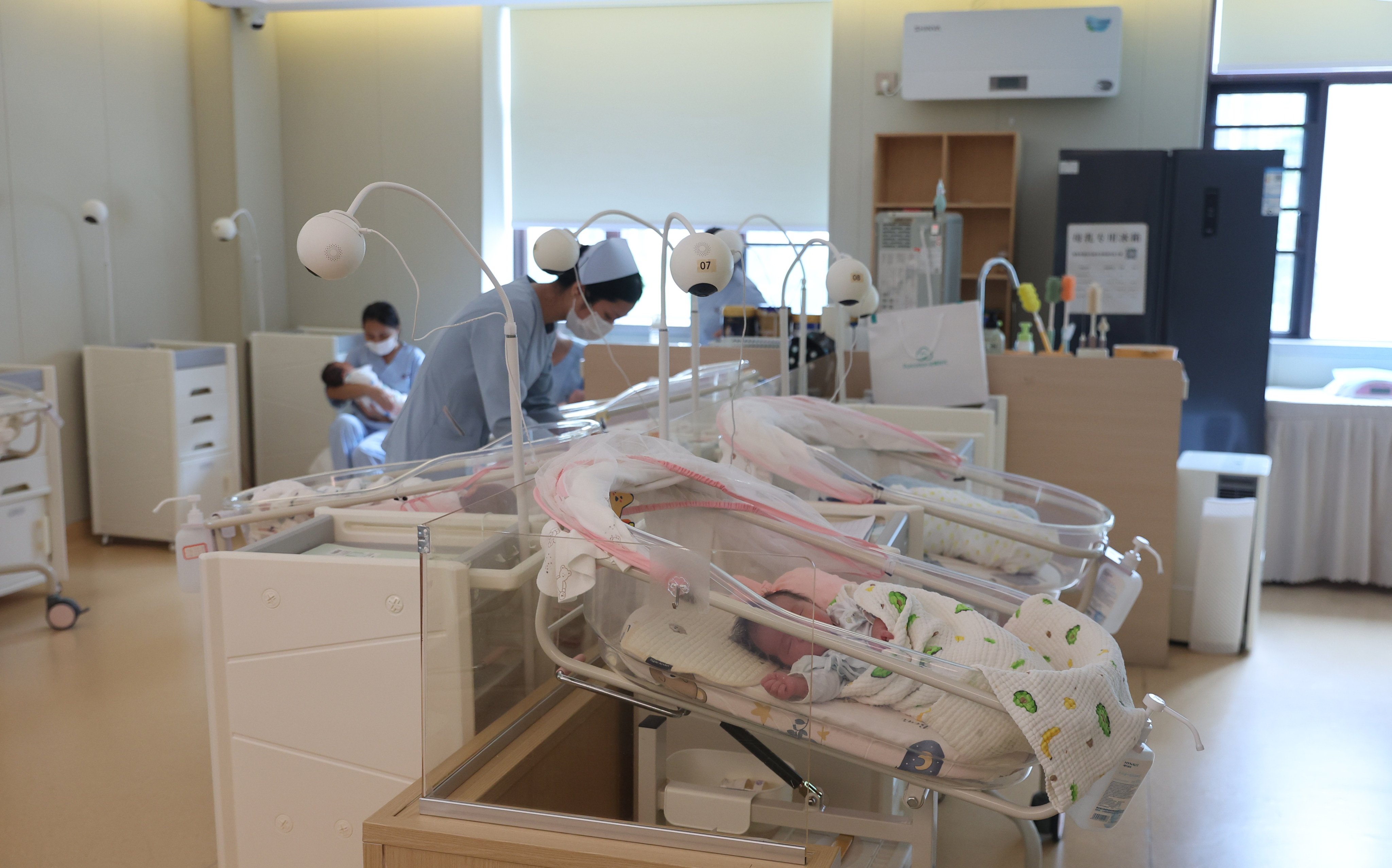 Nursing staff take care of infants at Onyuma Maternity Centre in Shenzhen. Photo: Edmond So