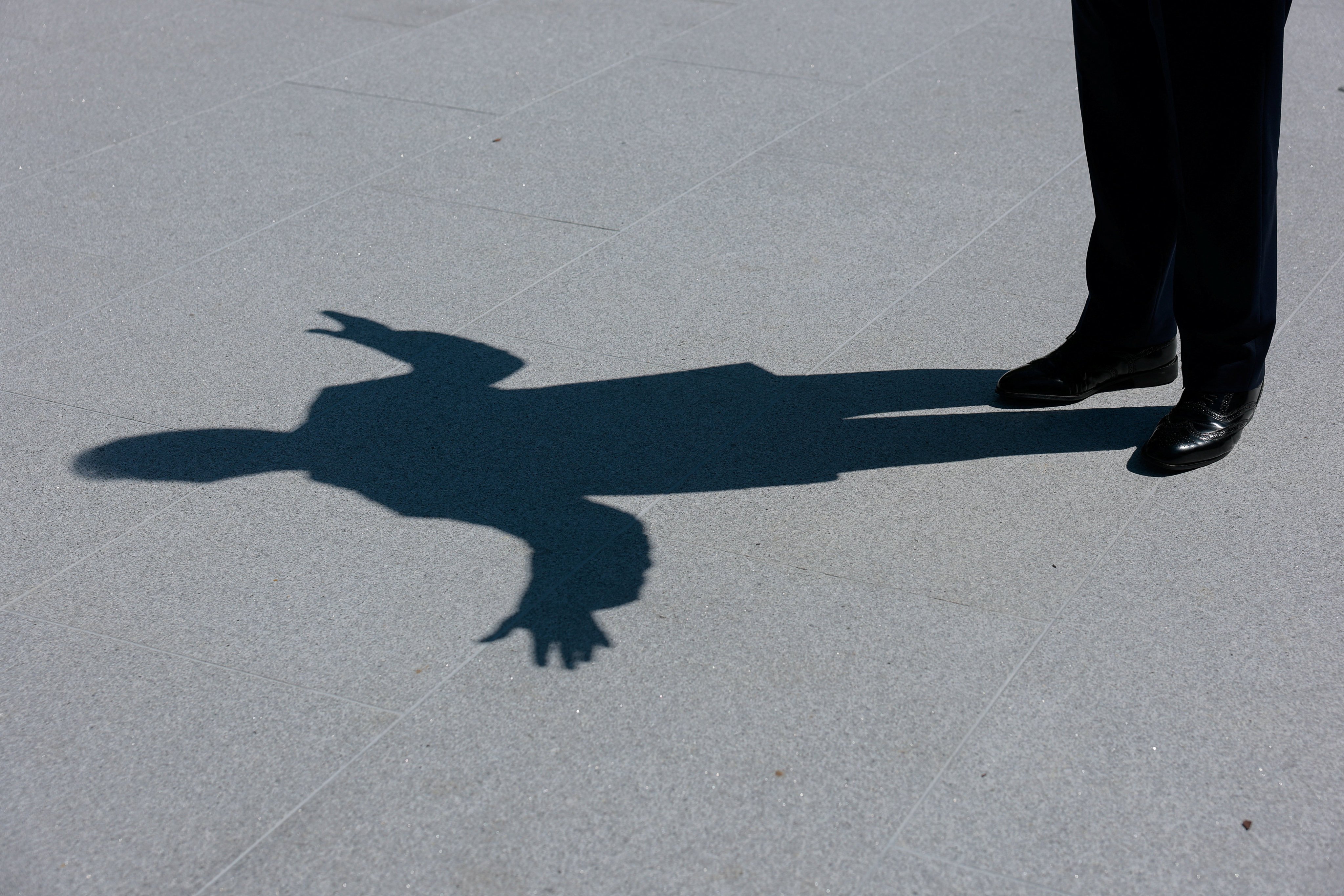 US President Donald Trump’s shadow is seen as he speaks to reporters at the White House in August. Photo: Reuters