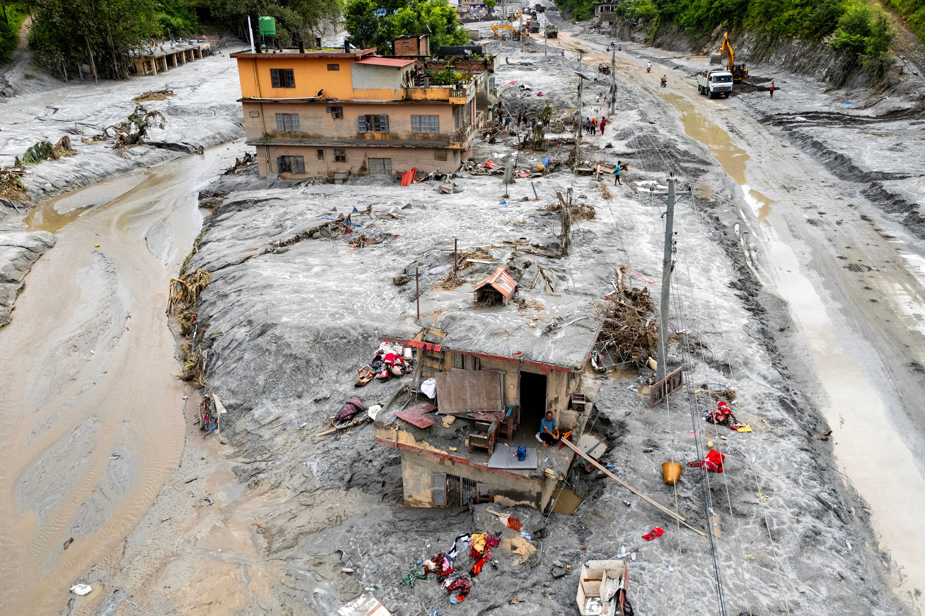 Om Bahadur sitting on the ledge of his damaged house on September 2, a week after the devastating flash floods at Baireni in Nepal’s Dhading district. Photo: AFP/Getty Images/TNS
