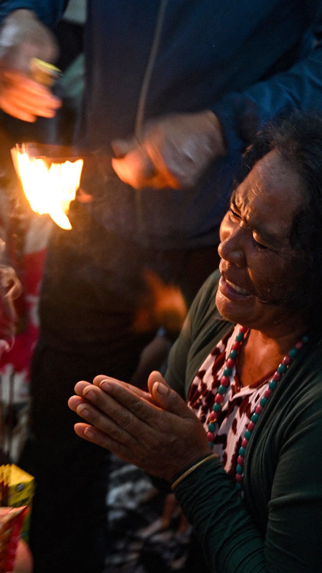 A relative grieves during a prayer meet held for missing flash flood victims in Nepal