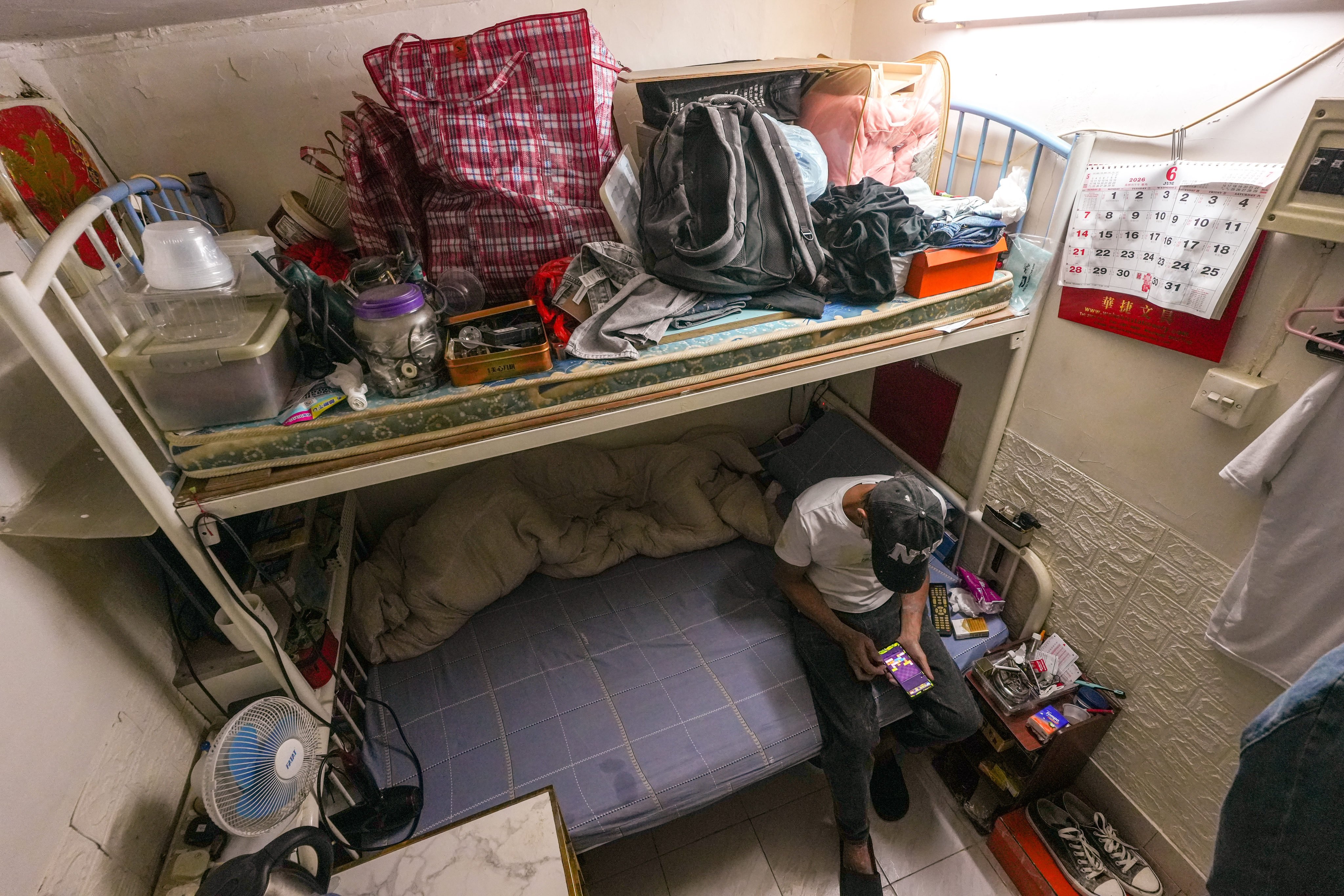 A resident in his subdivided flat in Sham Shui Po. Photo: Sun Yeung