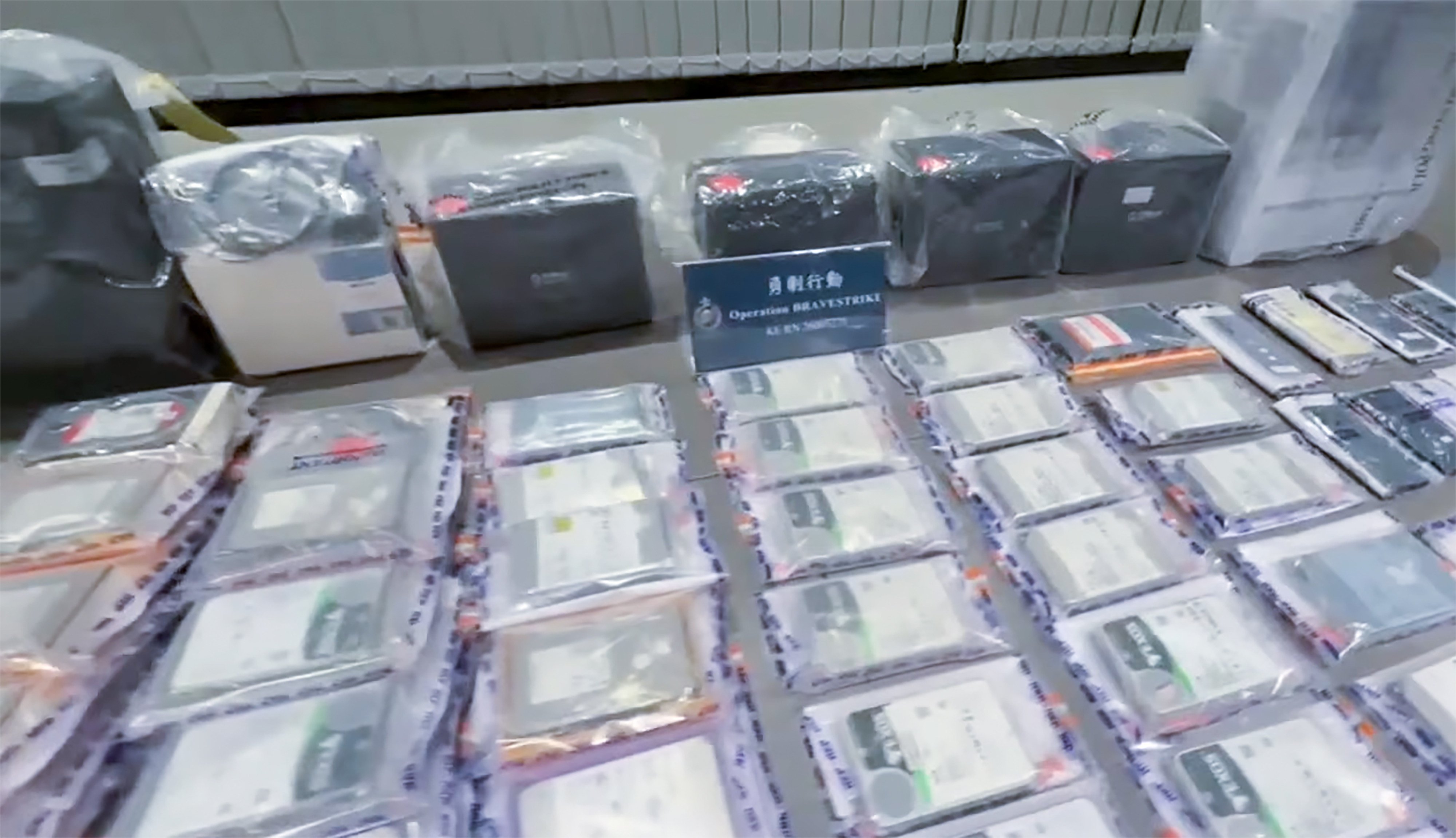 Police officers seized 24 smartphones, three tablets, 11 computers and 53 external storage drives during the operation. Photo: Handout