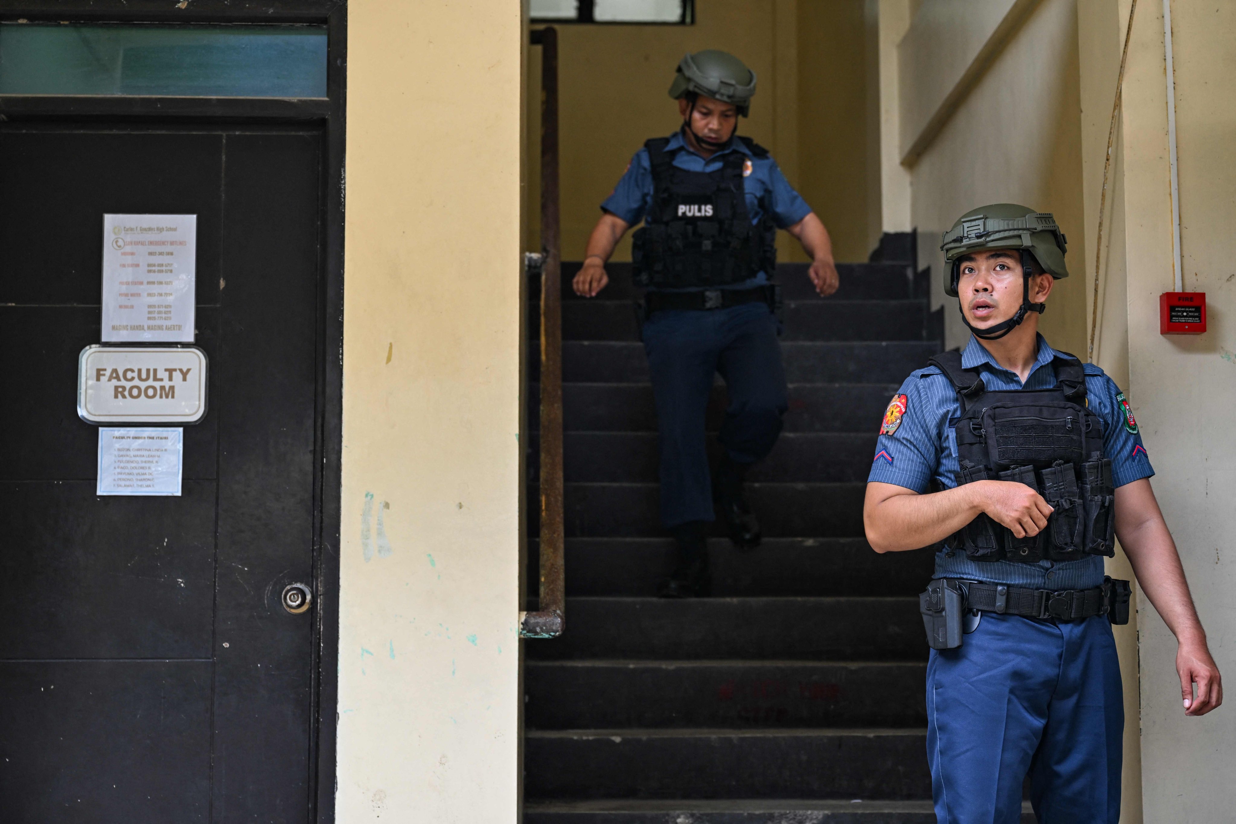 Policemen take part in nationwide school drills to safeguard students from armed intruders, at a school in Bulacan, the Philippines, on Thursday. Photo: AFP