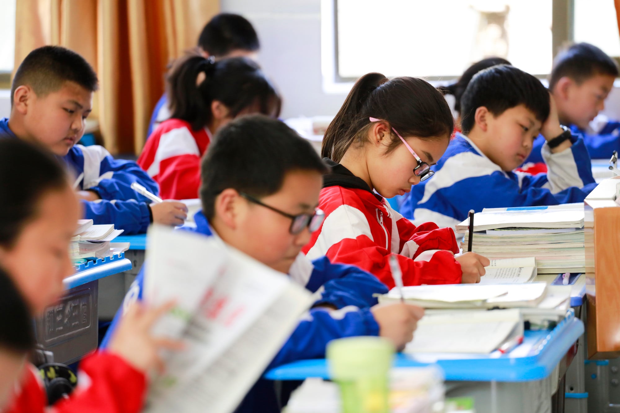 Students focusing on intense classroom work. Driven by heavy study loads, China’s student myopia rate ranks among the highest globally. Photo: Shutterstock Students focusing on intense classroom work. Driven by heavy study loads, China’s student myopia rate ranks among the highest globally. Photo: Shutterstock