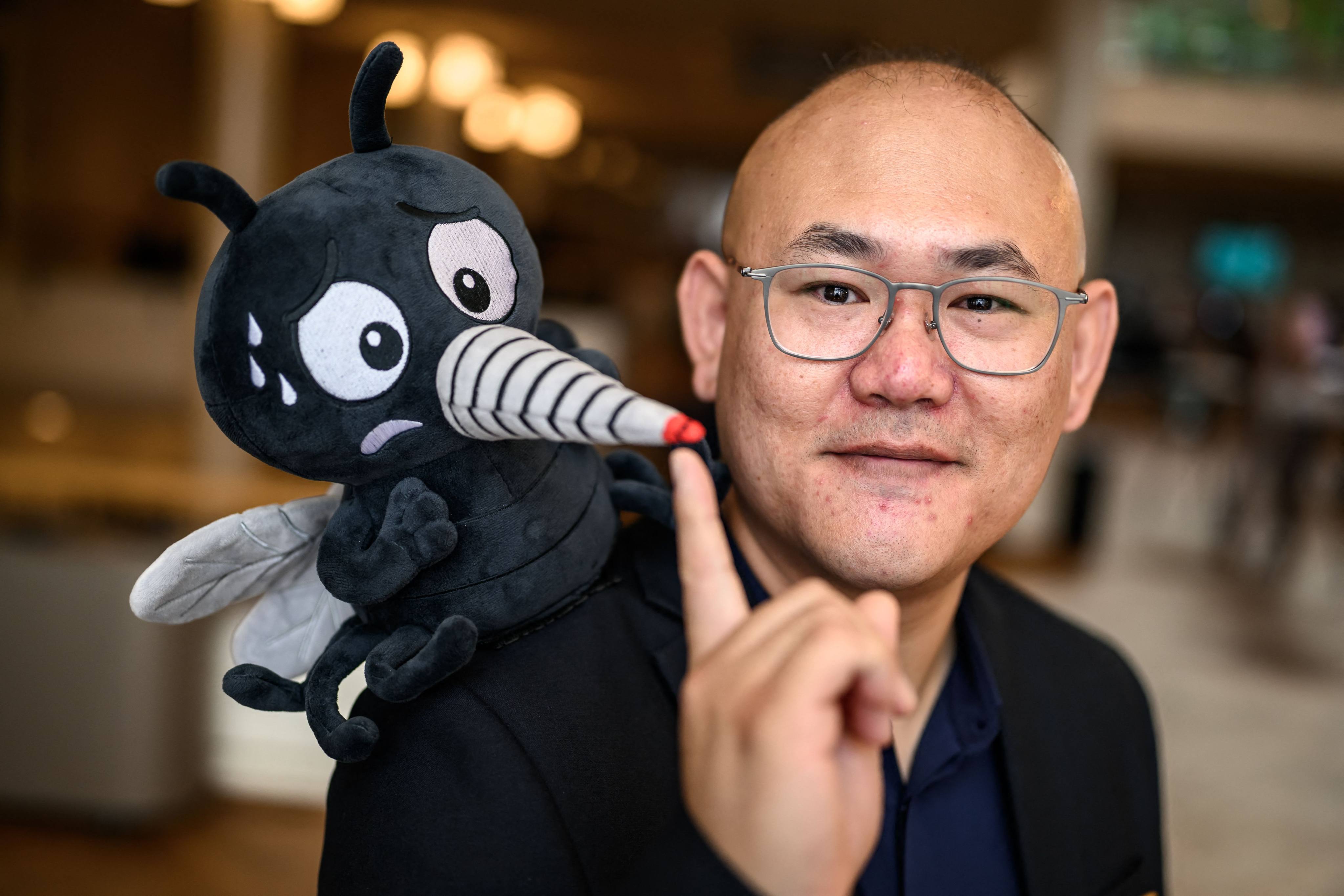 Canadian Associate Professor Changhong Cao poses with a fake mosquito. Cao and his team were awarded the Ig Nobel Prize in technology for pioneering the use of mosquito proboscises as high-resolution 3D printing nozzles, a process called Necroprinting. Photo: AFP