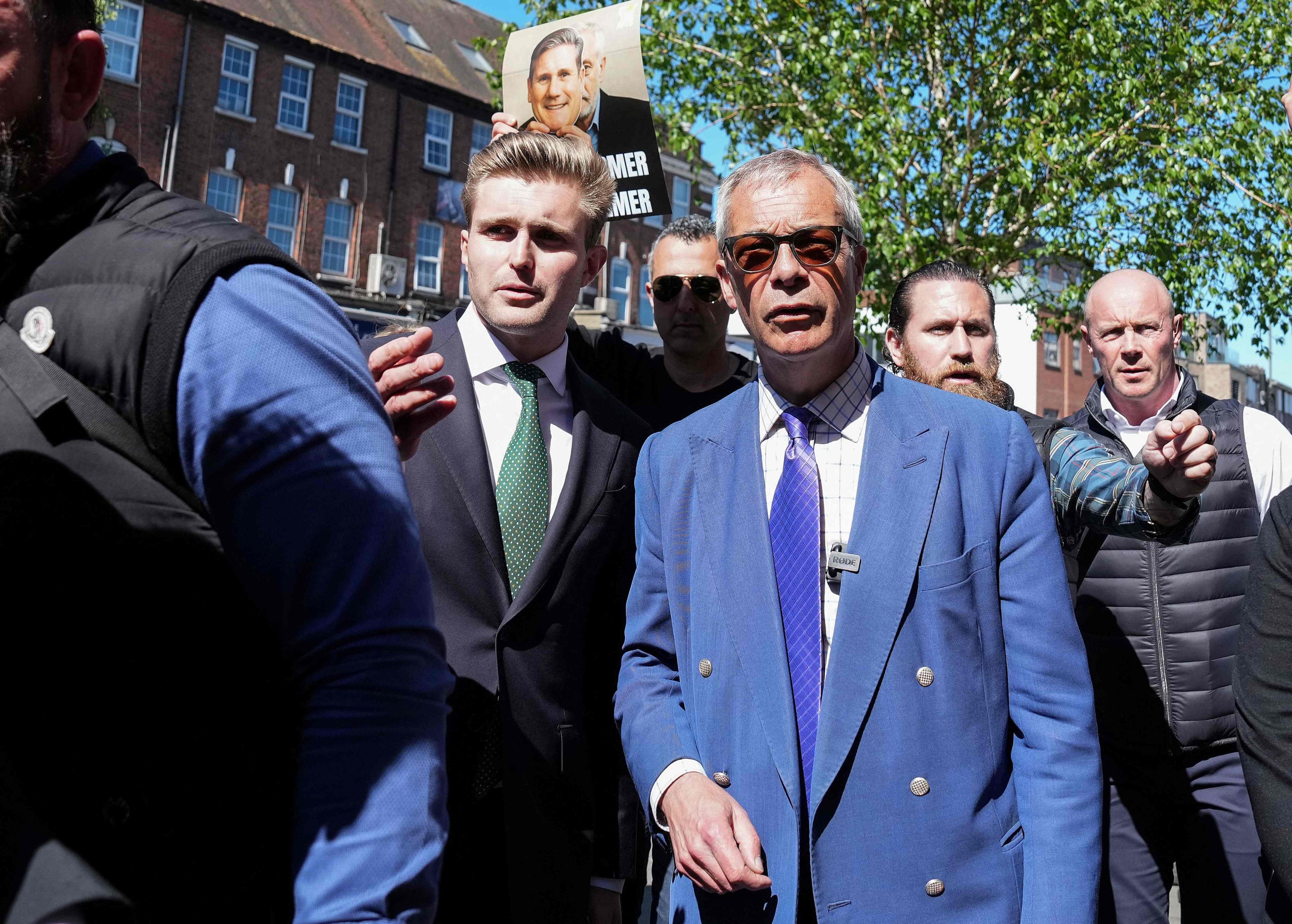 Reform UK party leader Nigel Farage (centre), talks with Dan Jukes (centre left) as he visits the area where two men were stabbed the day before in Golders Green, north London, on April 30. Photo: AFP