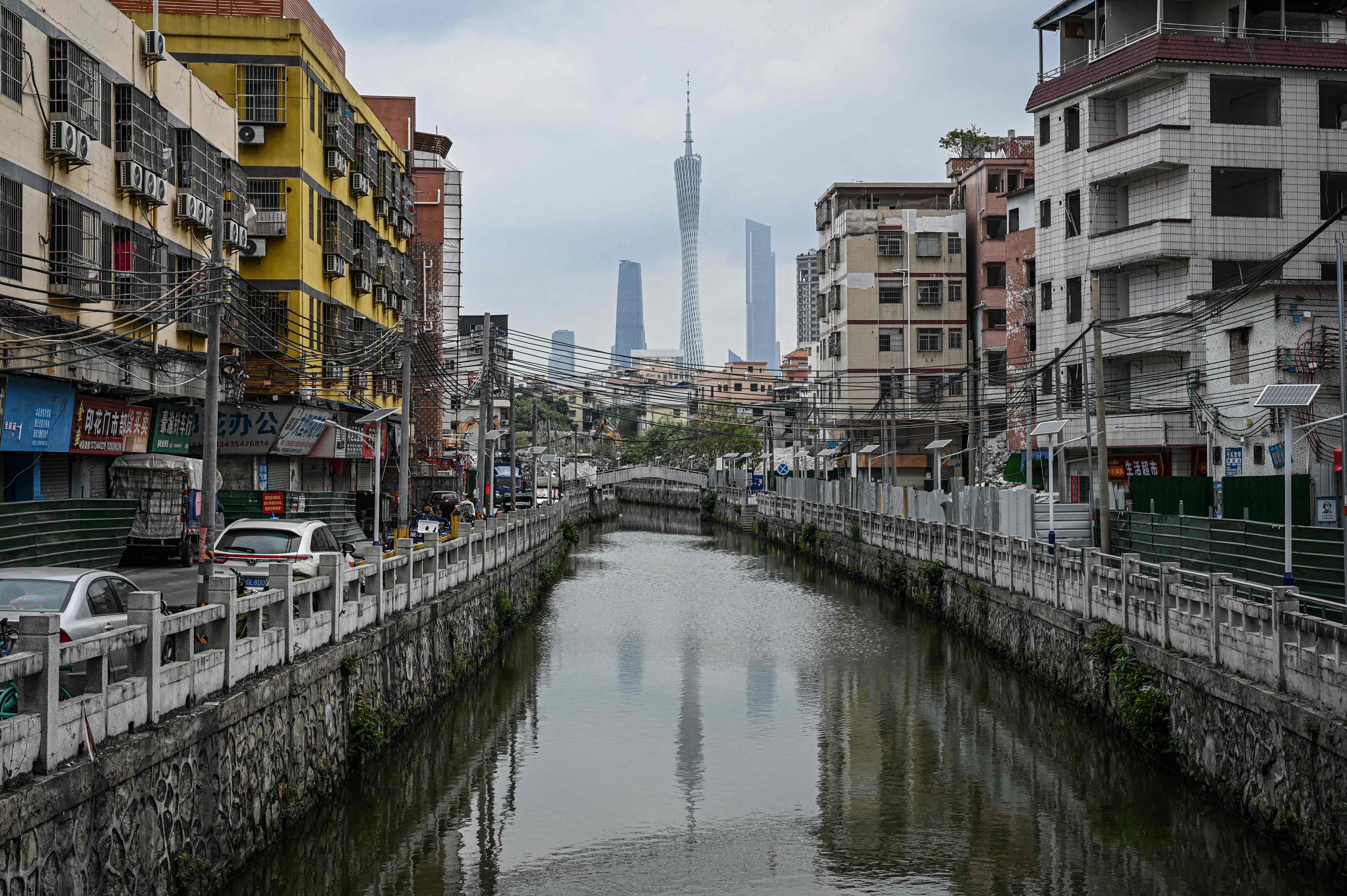 The city skyline rises over a canal in an urban village in Guangzhou, in southern China’s Guangdong province, on April 16. Photo: AFP