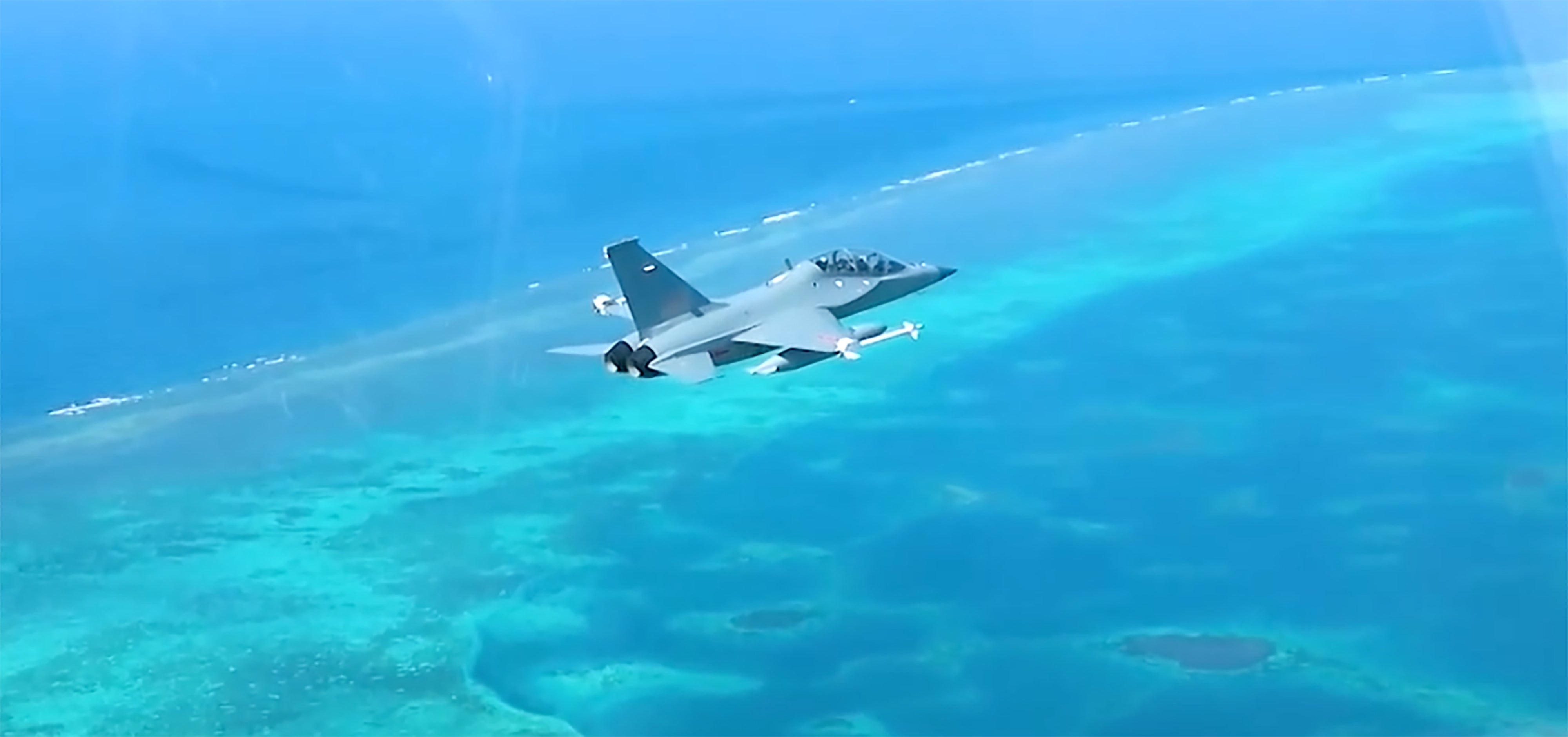 A Chinese JL-10 trainer jet flies over Scarborough Shoal on Wednesday. Photo: CCTV