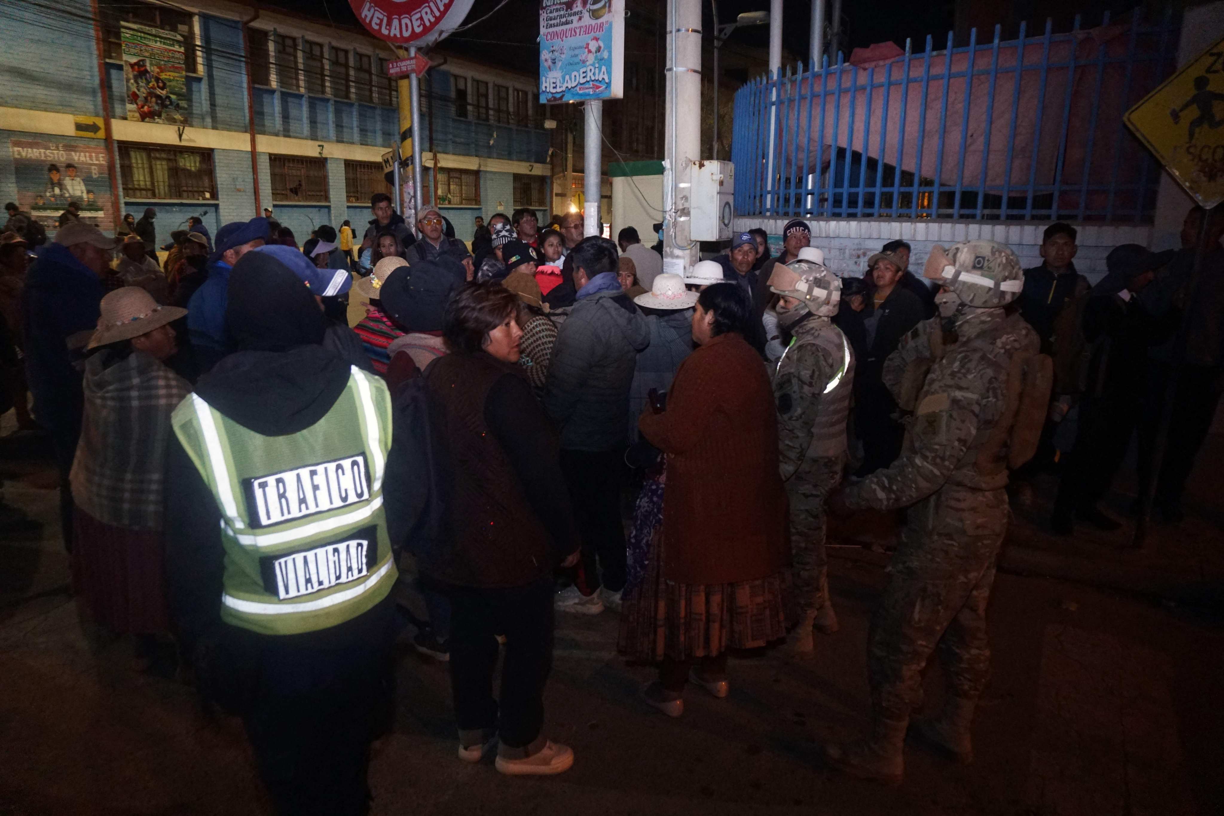Military personnel evacuating civilians near the site of an explosion at an army barracks in Viacha, Bolivia, on Friday. Photo: AFP