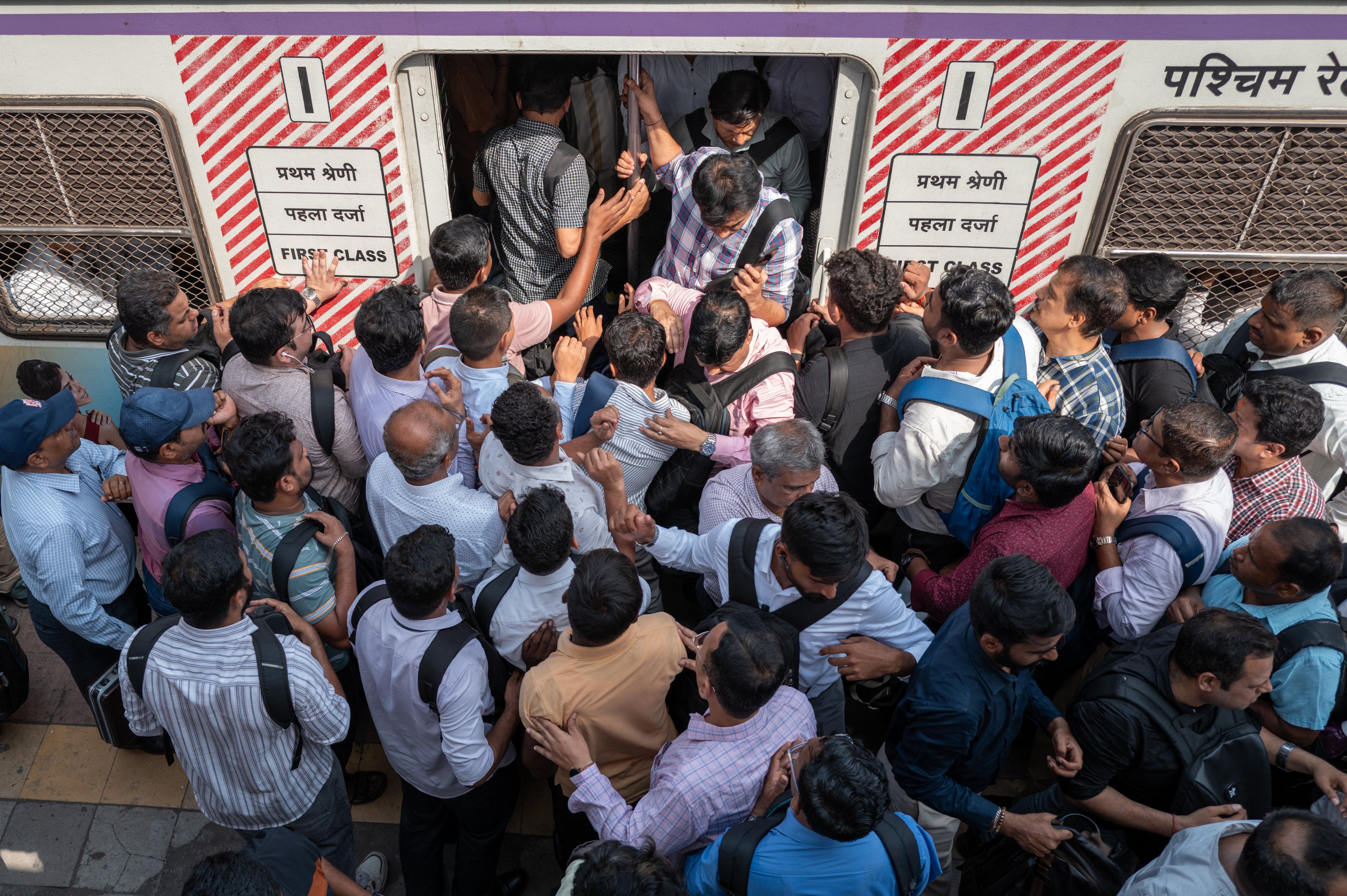 Passengers gather to board a crowded train at a railway station in Mumbai. India’s Haryana state aims to train and place up to 50,000 young workers and technical professionals for placements in Japan. Photo: AFP