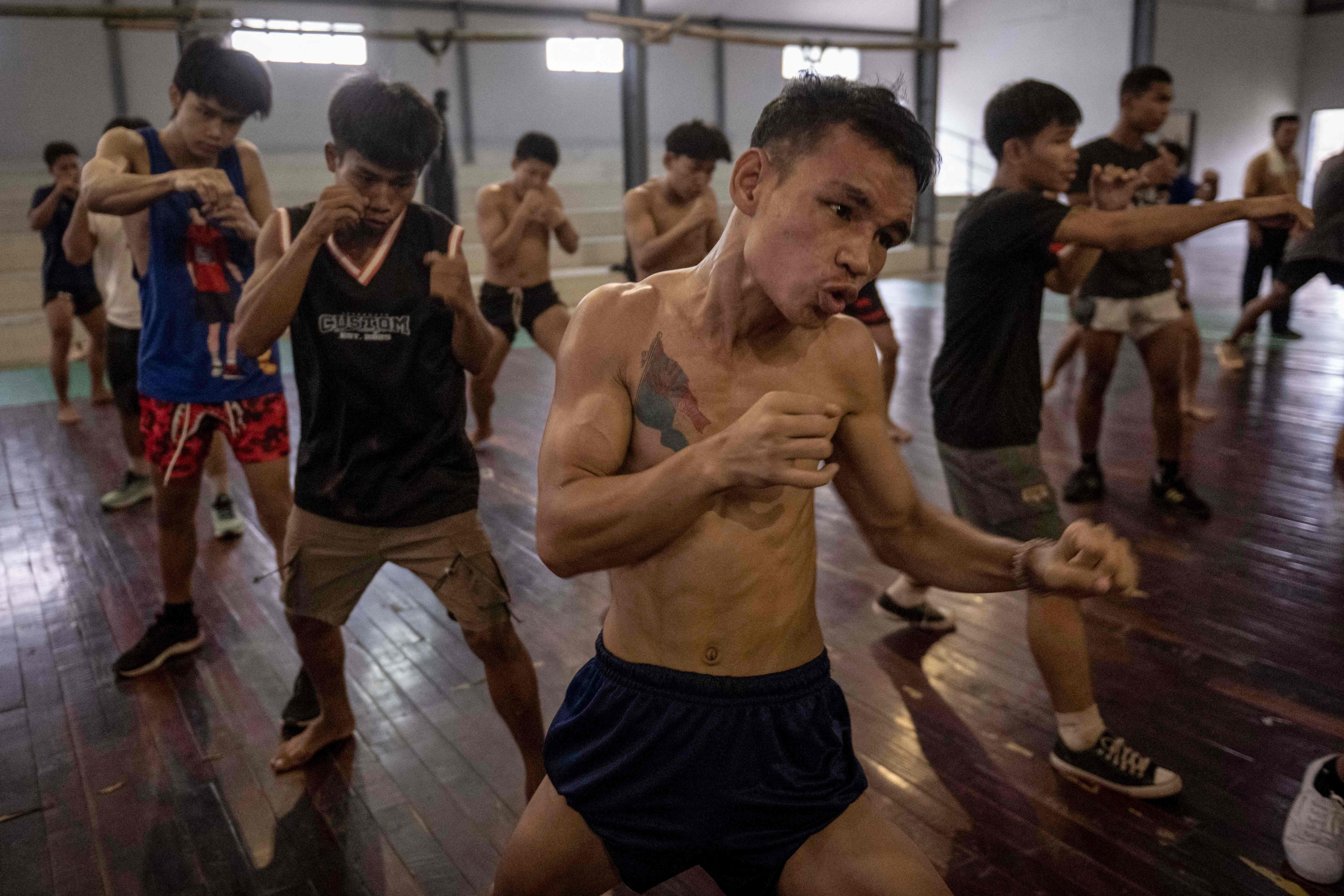 Lethwei fighters at a training camp in Hpa-an in Myanmar’s Kayin state in May. In a country consumed by conflict, the sport, which is defined by brutality, dominates. Photo: AFP