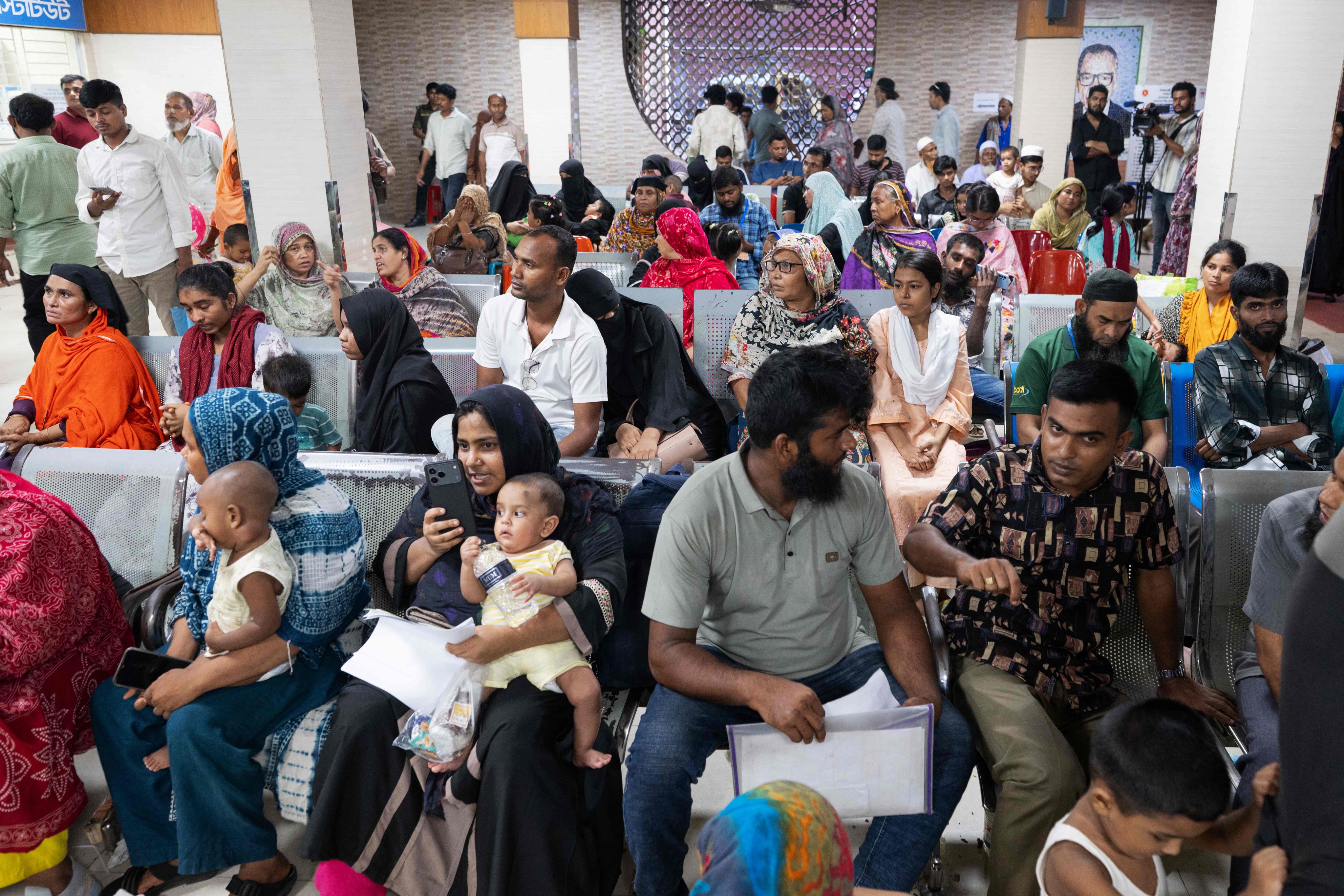 Parents wait with their children to receive treatment for measles in Dhaka on Thursday. Photo: AFP
