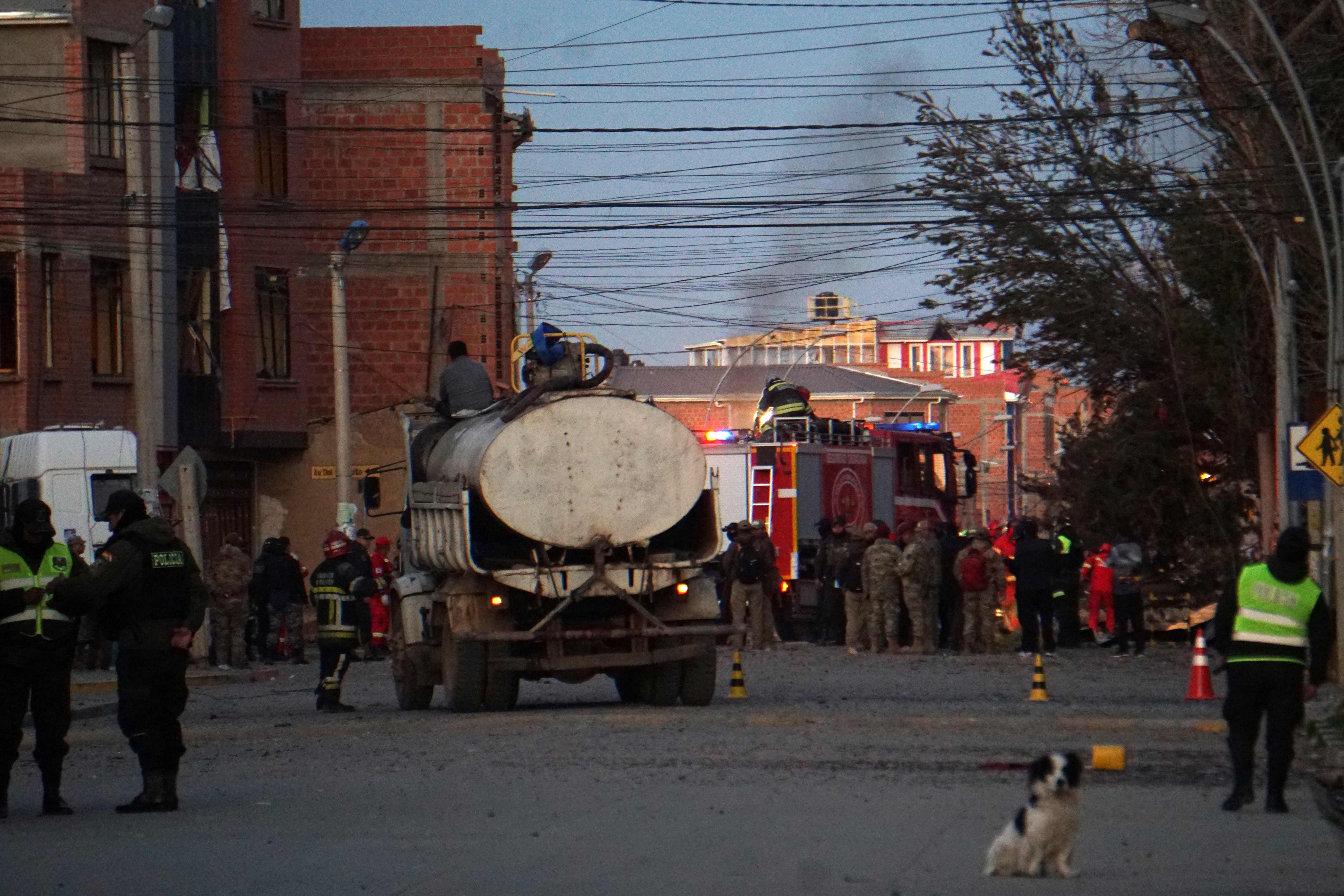 Firefighters, police officers and military personnel at the site of an explosion at an army barracks in Viacha, Bolivia, on Friday. Photo: AFP