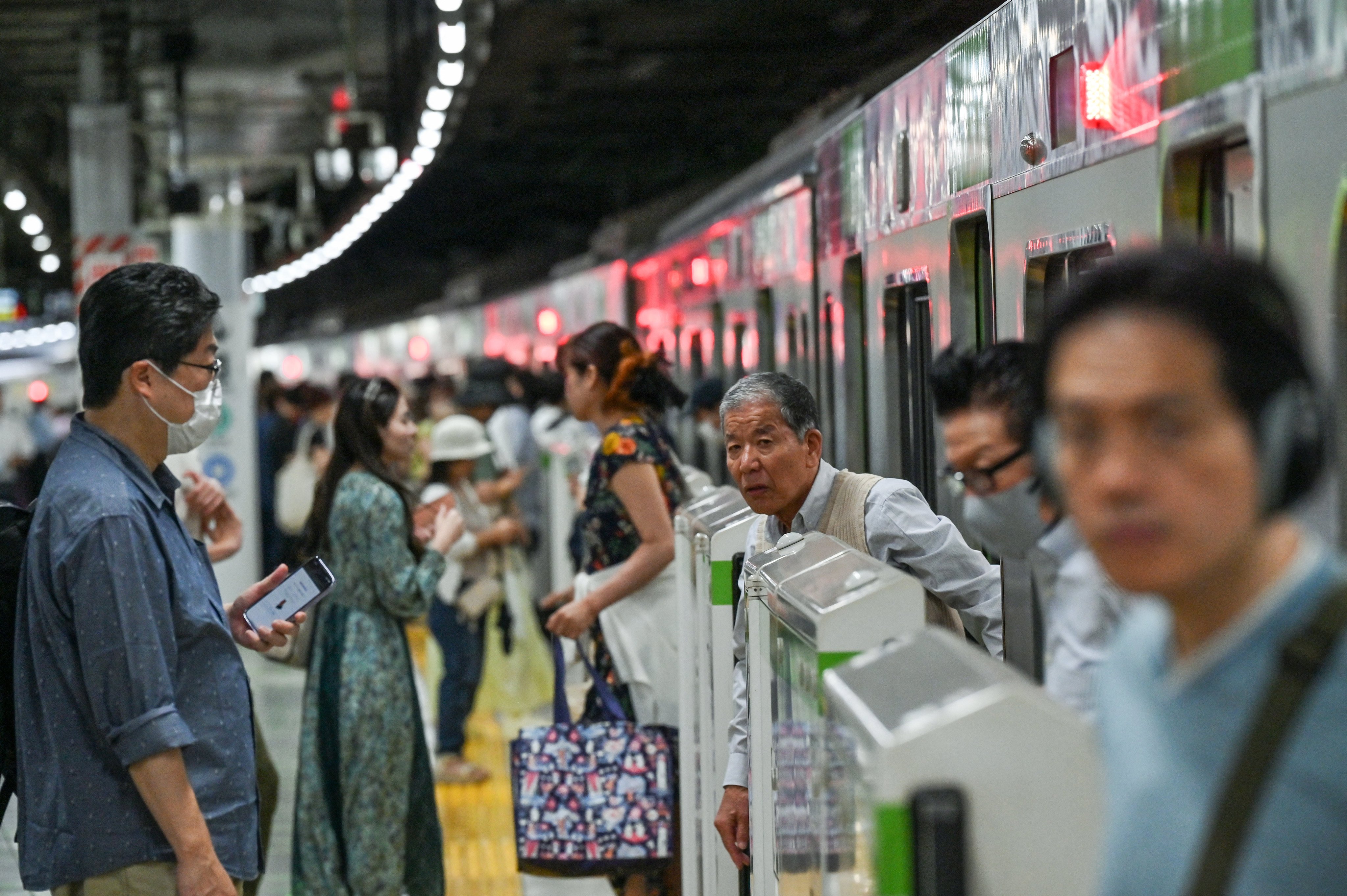 Passengers disembark from a train in Tokyo. Japan’s workforce is rapidly ageing. Photo: AFP
