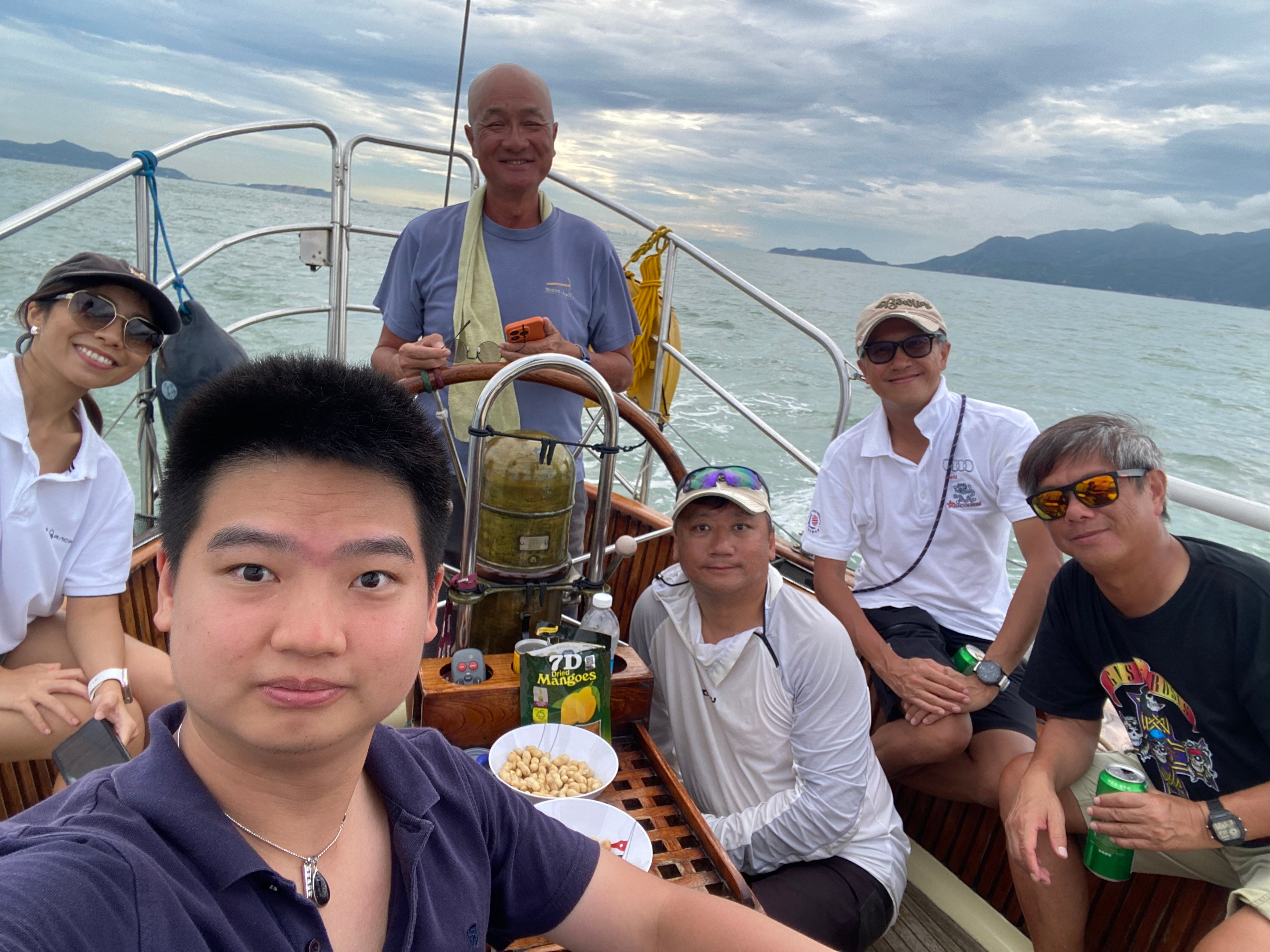 SCMP reporter Lam Ka-sing (second left) aboard the yacht Bowline, with Alex Yu (standing) and crew, on the trip back to Hong Kong. Photo: Lam Ka-sing