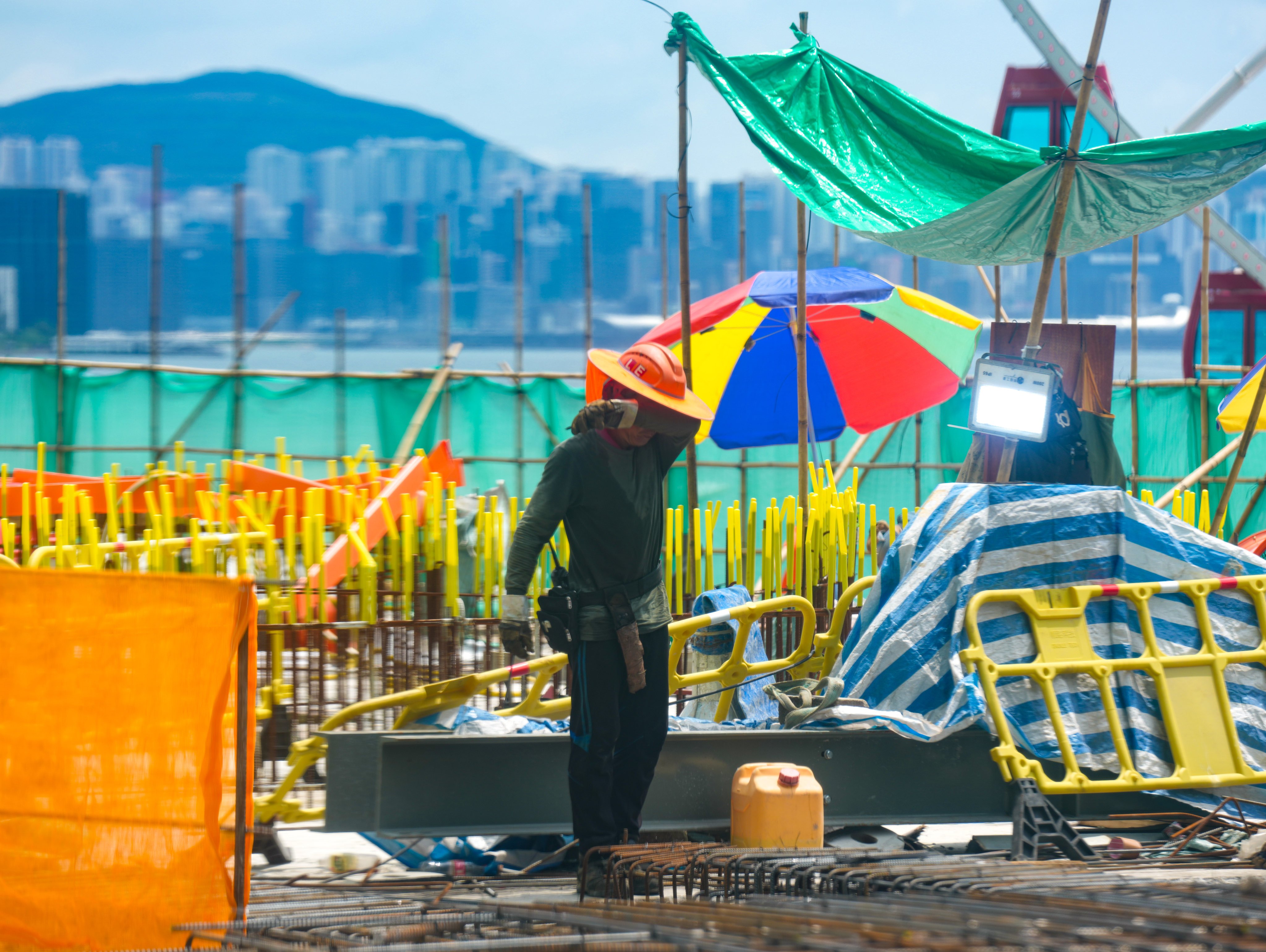 A worker on duty at a construction site at Central. Hong Kong is studying the performance of a revamped heat warning system, the labour chief has said. Photo: Sam Tsang
