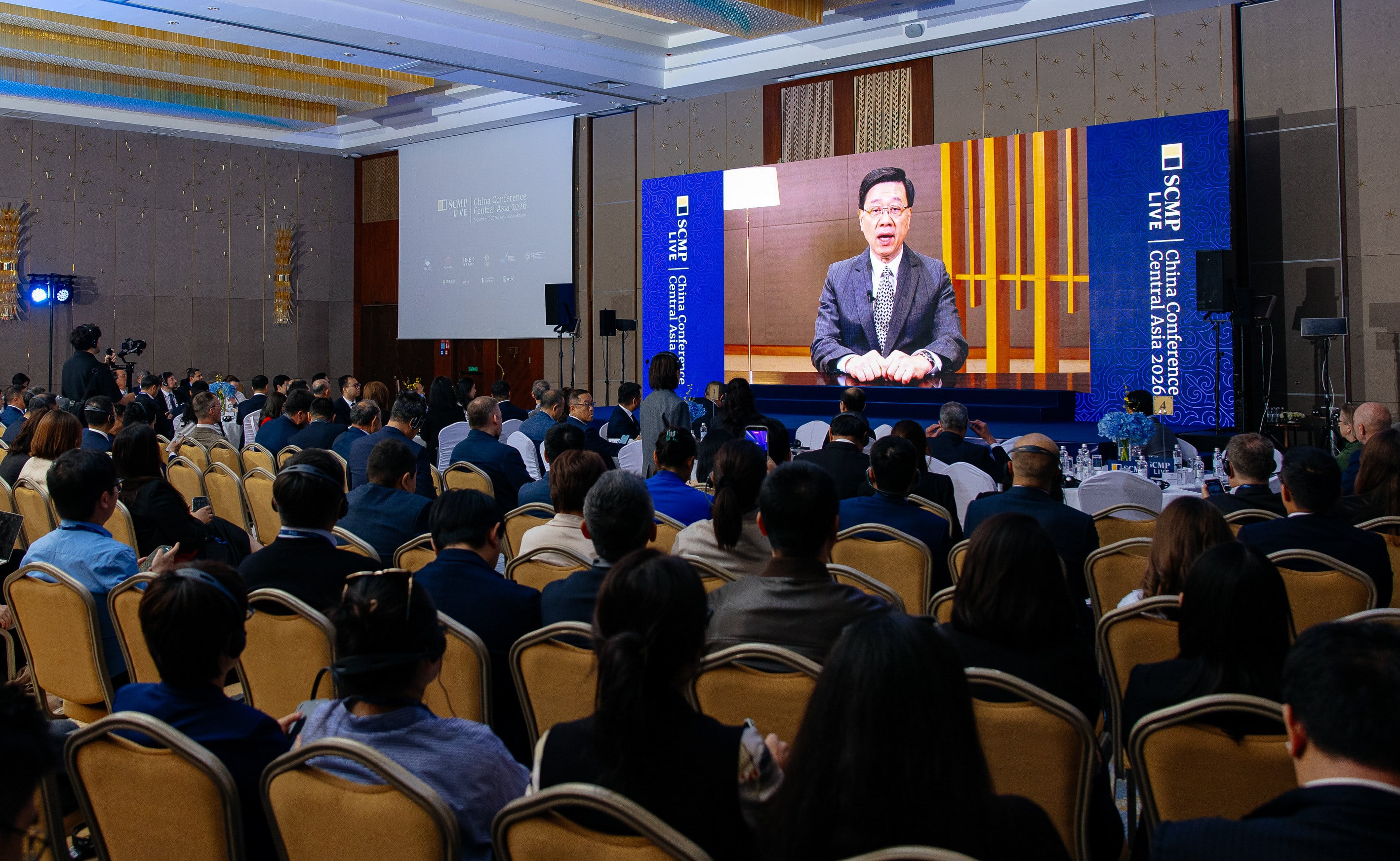 Chief Executive John Lee addresses the South China Morning Post’s China Conference: Central Asia 2026 by video link on Monday. Photo: SCMP