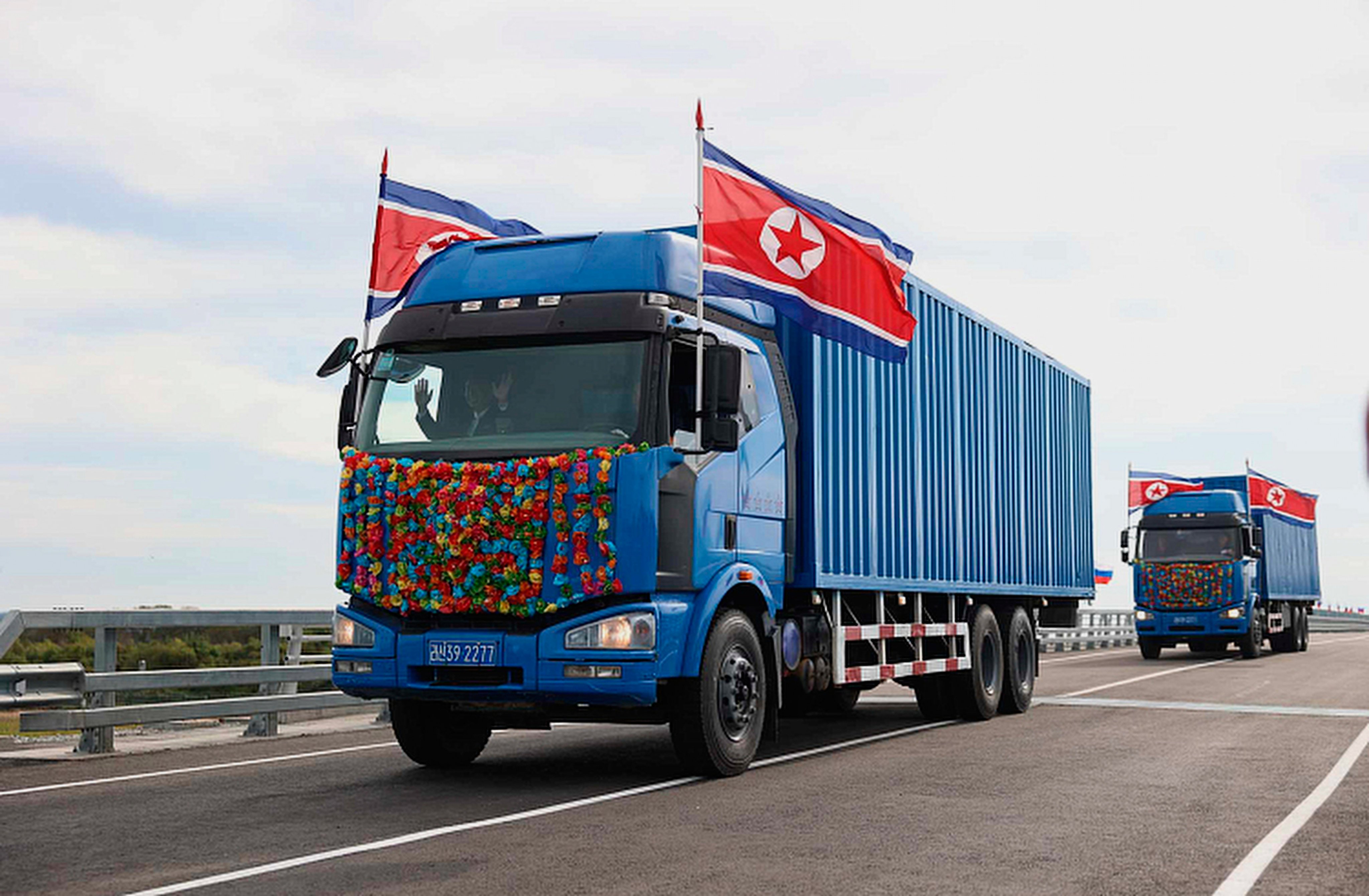 North Korean trucks drive across the new bridge between Russia and North Korea over the Tumen river in Russia’s Primorsky Krai region on Monday. Photo: Government of Primorsky Krai Region via AP