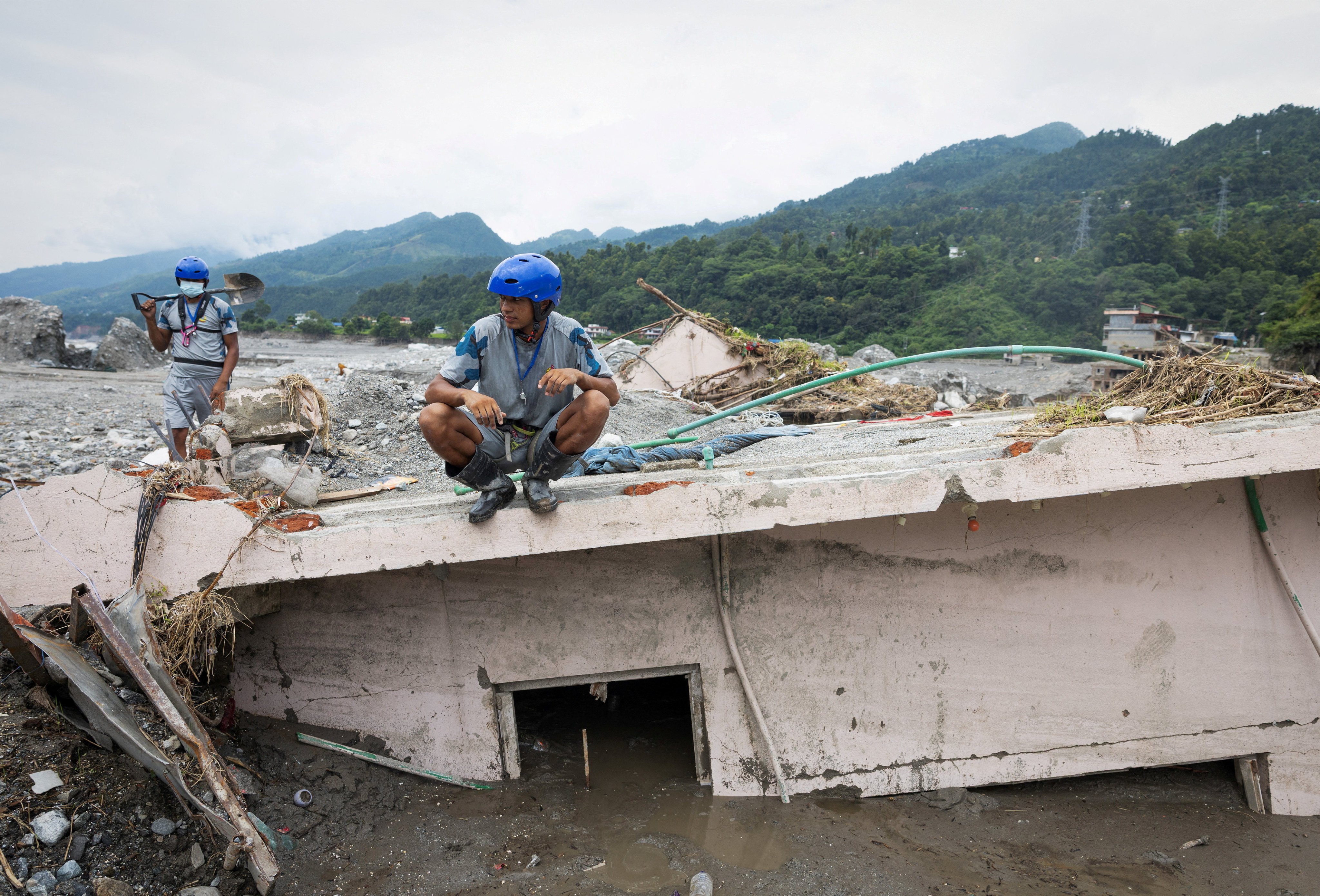 Police search for more survivors and victims of the deadly flash floods and mudslides, in Betrawati, Nuwakot district, Nepal, on Sunday. Photo: Reuters