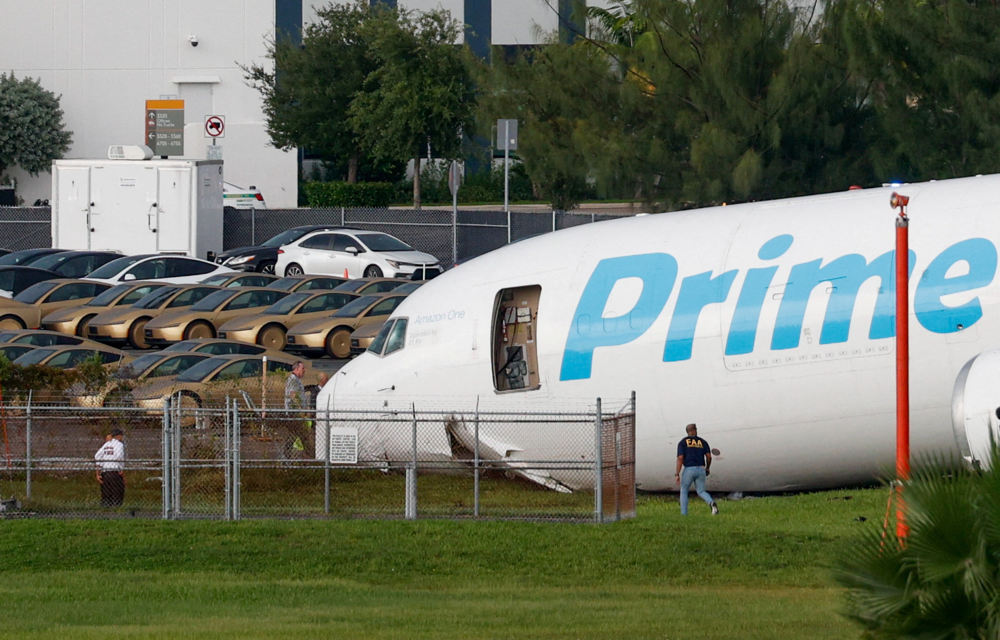 The crashed plane next to rows of Tesla Cybercabs. Photo: Reuters