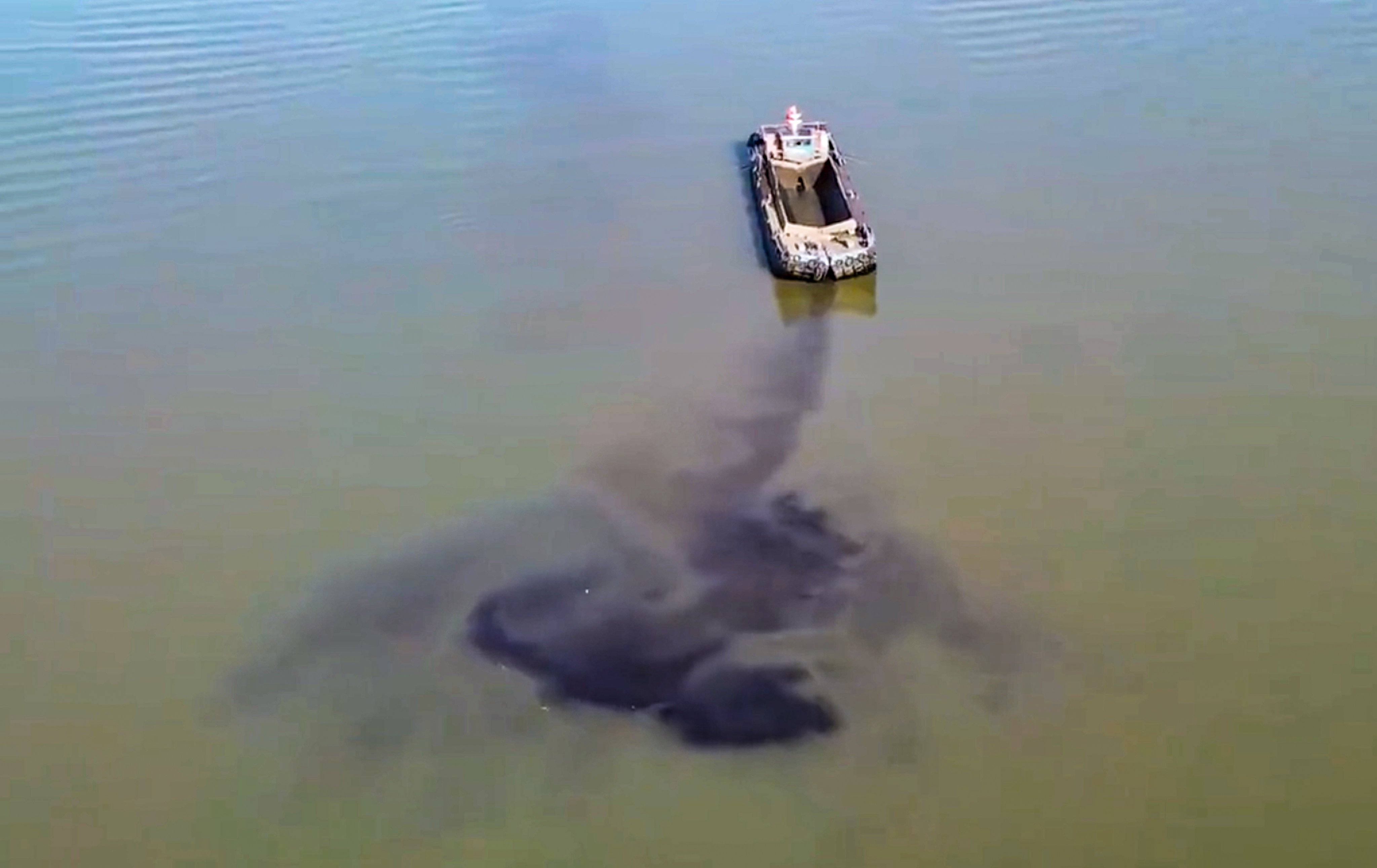 Drone footage posted online on Sunday showed  barges discharging an unknown black substance into the river near Tianxingzhou, an islet in the Wuhan section of the Yangtze. Photo: Handout