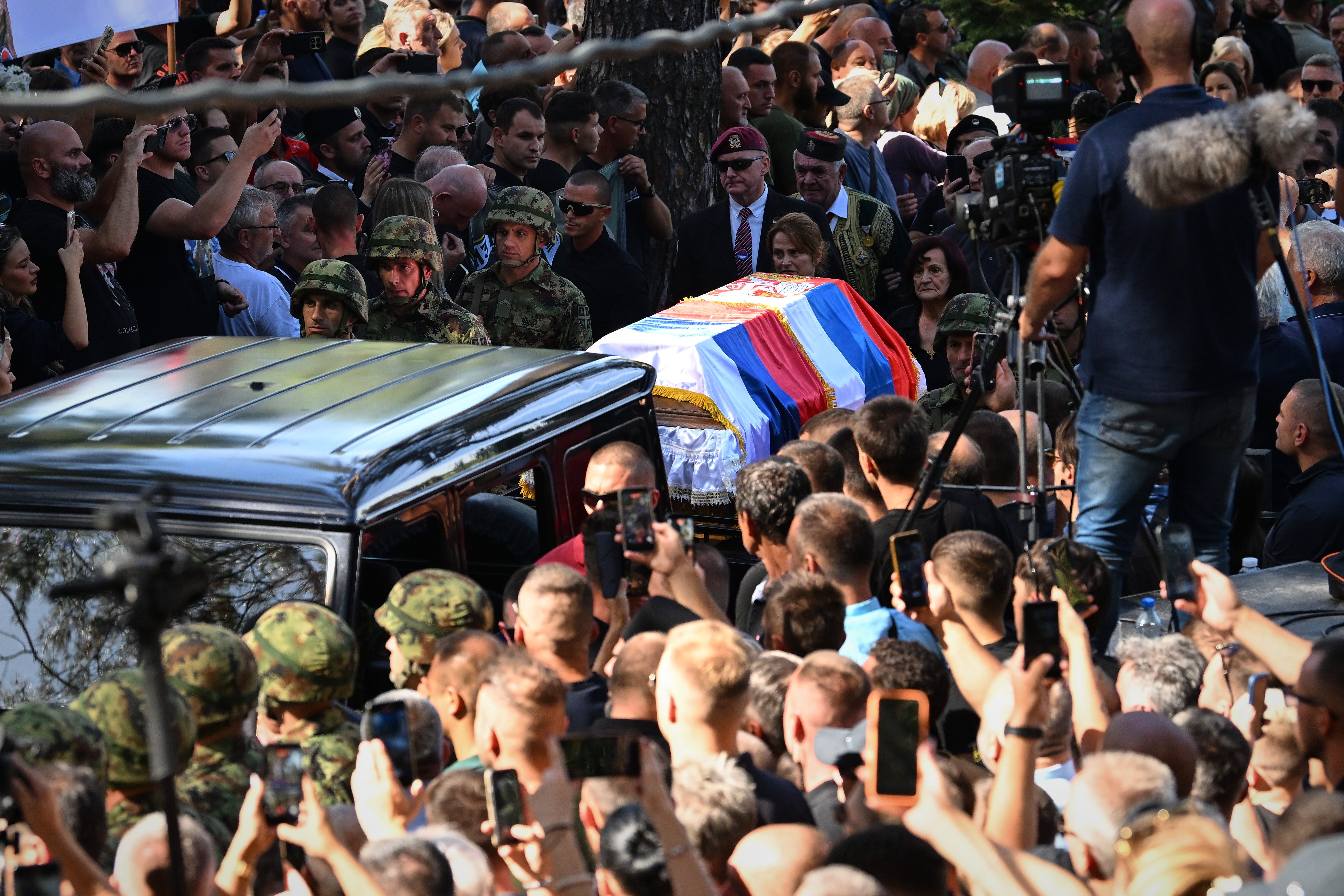 Serbian national military servicemen walk by the coffin of Mladic, who died last week while serving a life sentence for genocide and other atrocities during the war in Bosnia. Photo: AP