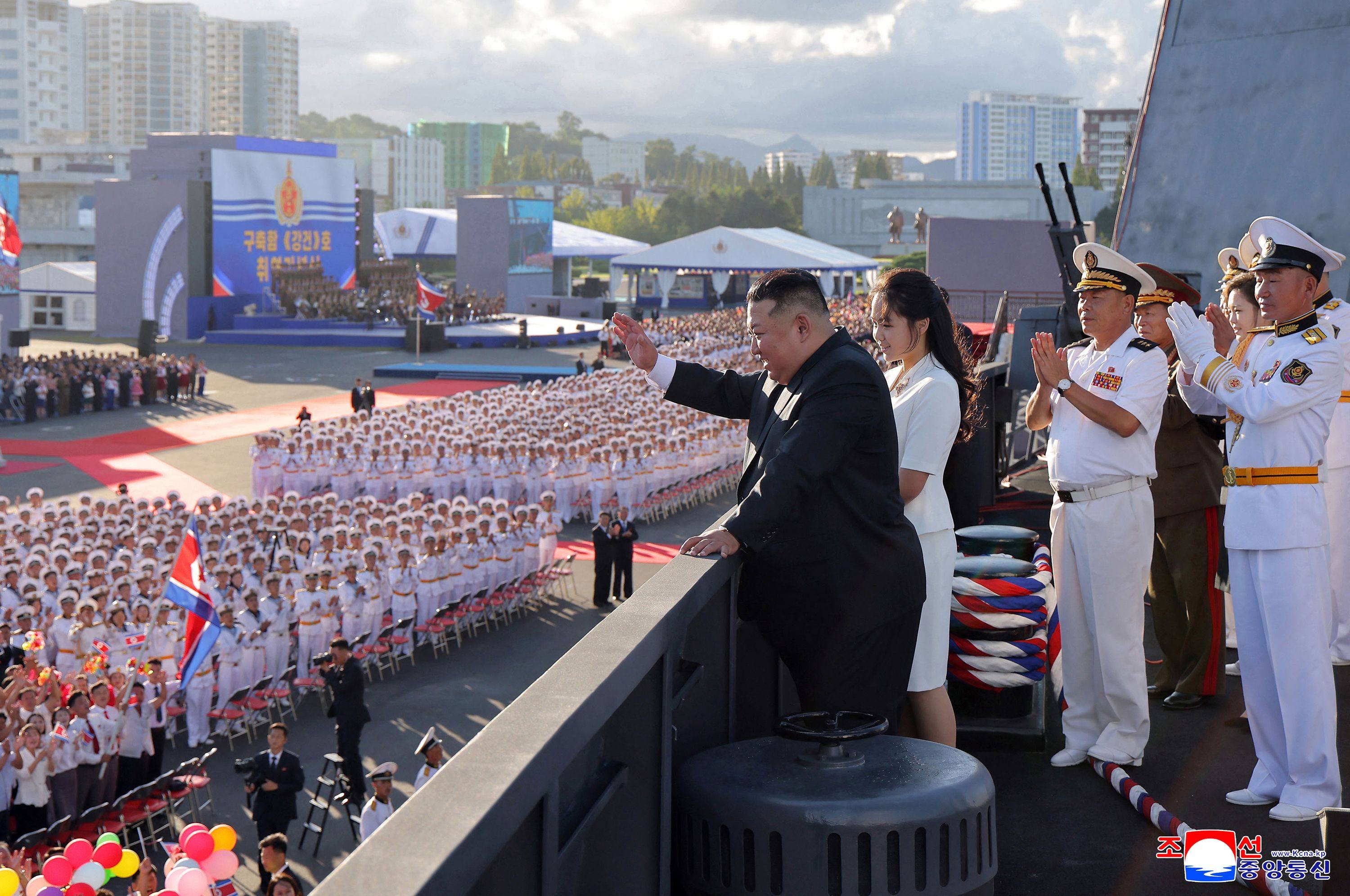 North Korean leader Kim Jong-un waves on board the Kang Kon on Sunday. Photo: KCNA / AFP