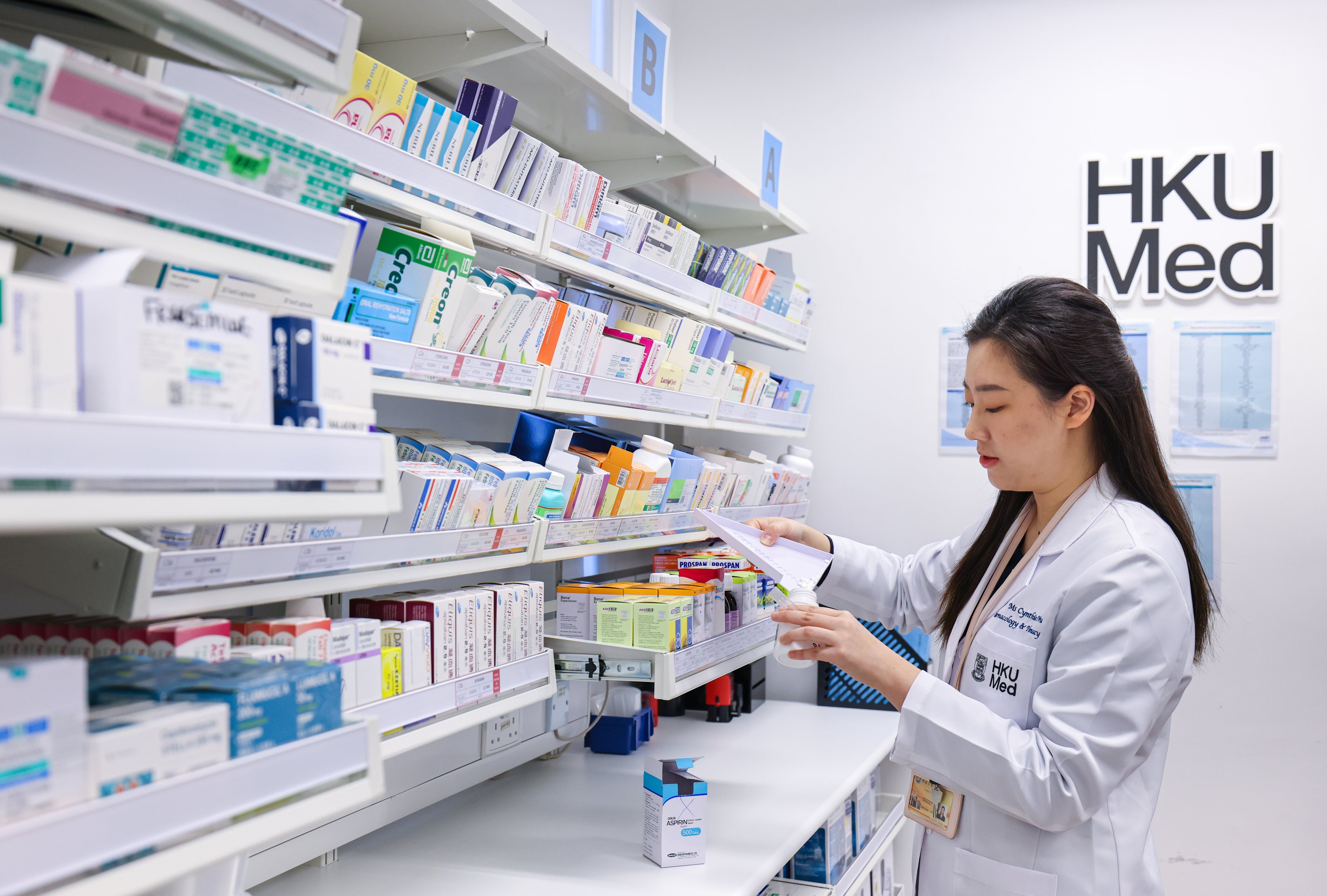 A pharmacist introduces services provided at an HKUMed Community Pharmacy in December 2024. The University of Hong Kong's Faculty of Medicine has revised its language requirements for admission. Photo: Nora Tam