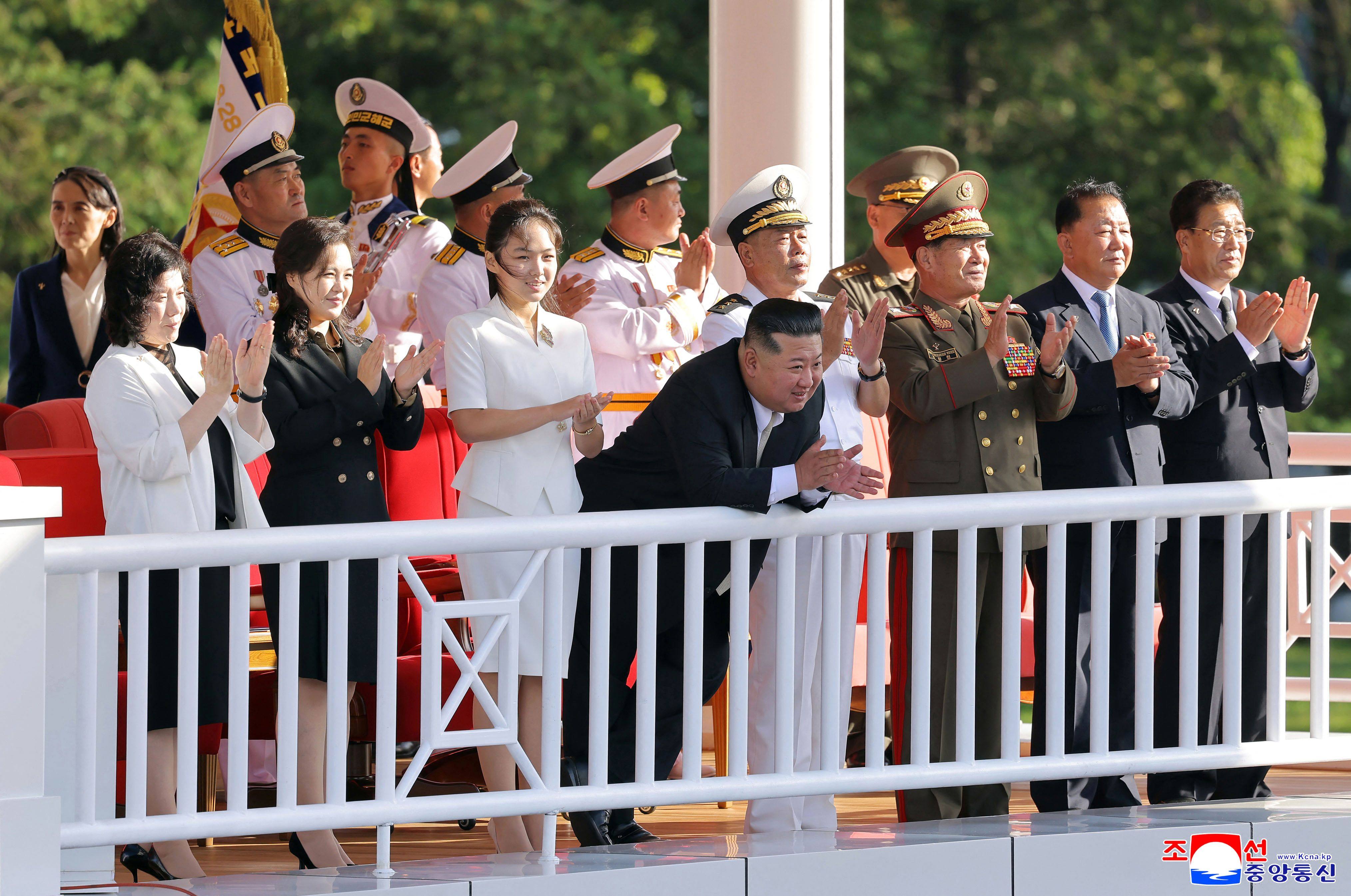 North Korean leader Kim Jong-un (centre) and his family watch the  commissioning ceremony for the destroyer Kang Kon at Wonsan Port on Sunday. Photo: KCNA / AFP