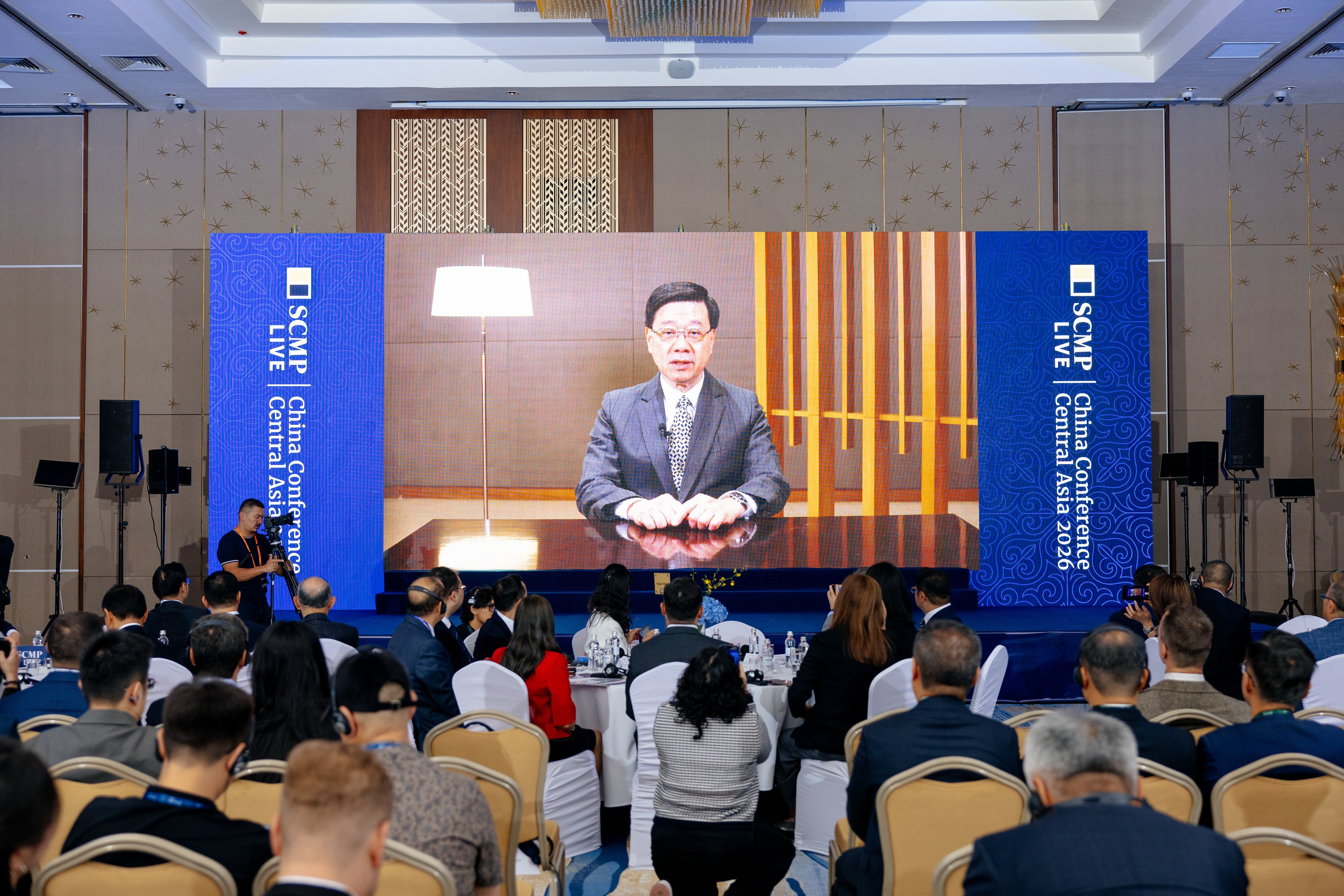 Chief Executive John Lee makes a virtual appearance at the conference. Photo: SCMP