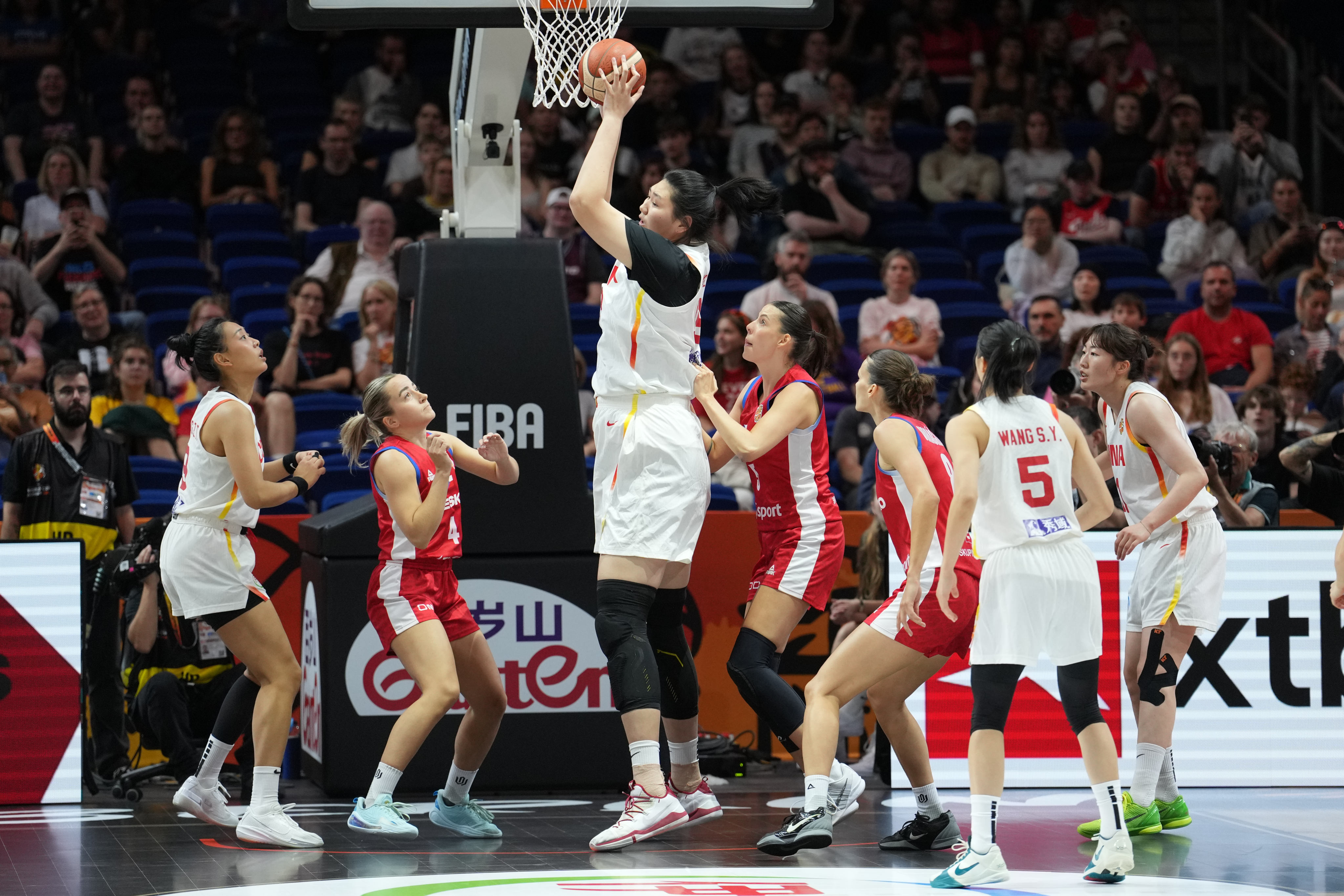 China’s Zhang Ziyu stands out in women’s basketball, as she does here against the Czech Republic, even in a sport where height matters. Photo: AP