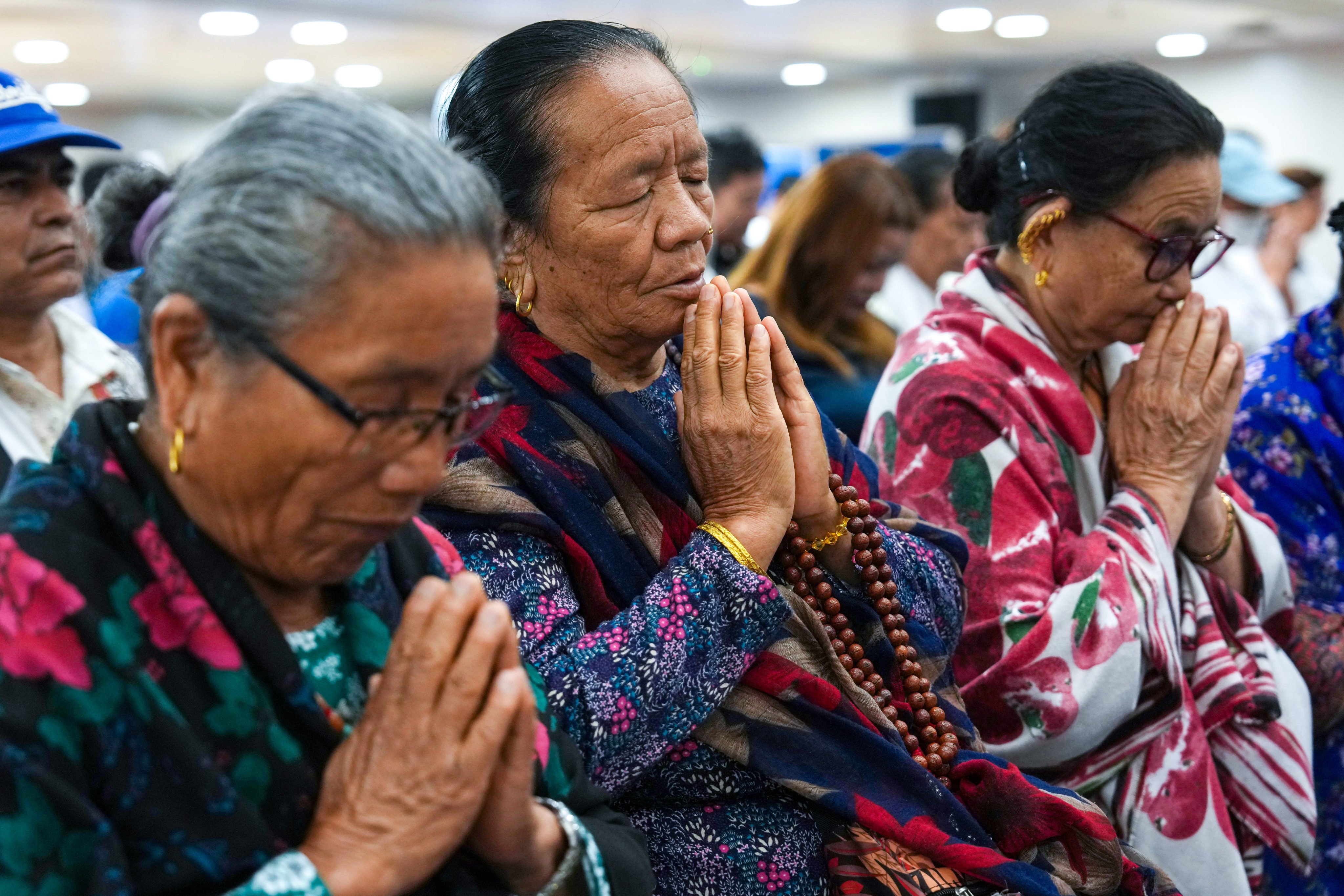 Attendees gather in prayer at the Henry G Leong Community Hall in Yau Ma Tei. Photo: Kit Lai