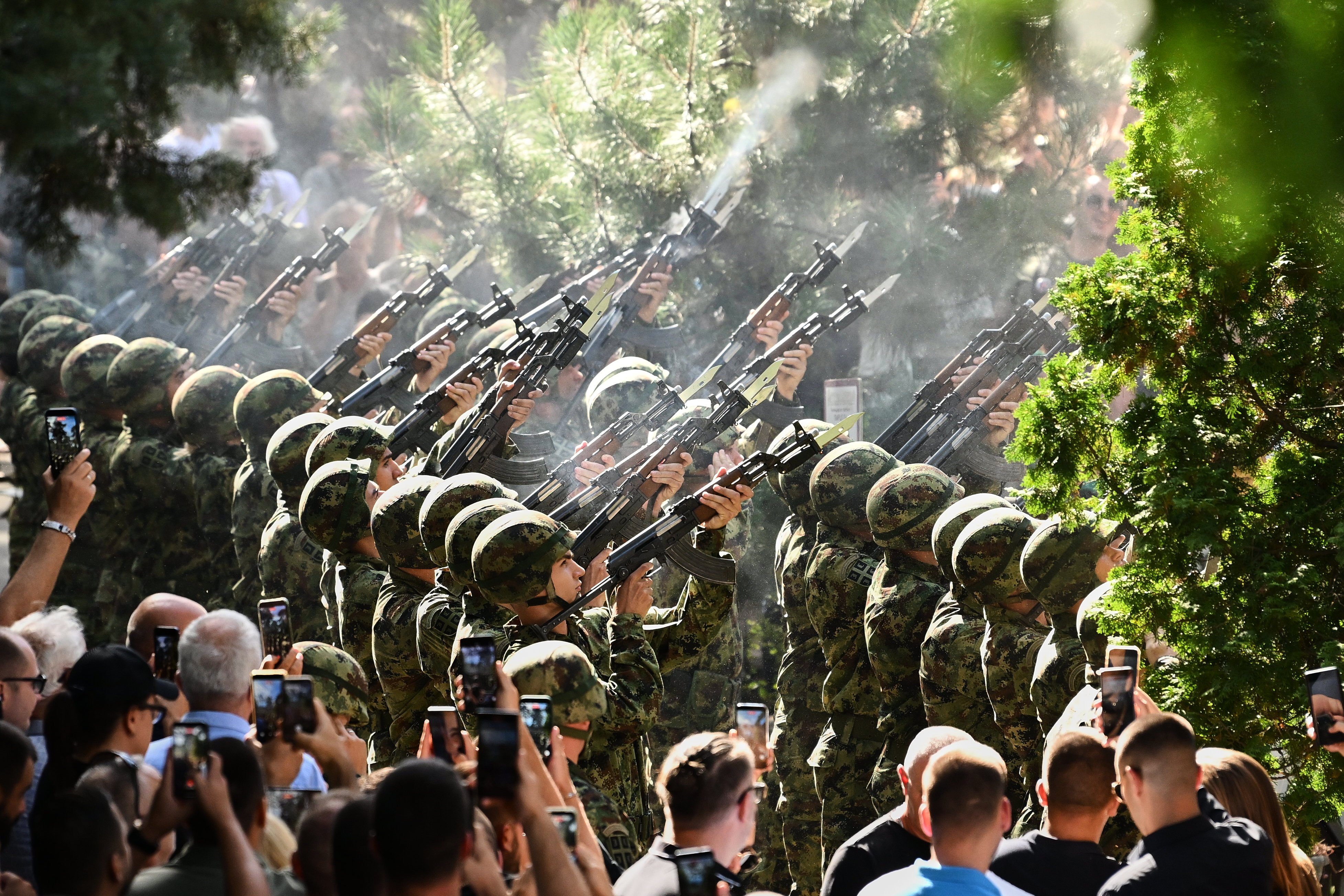 Serbian national military servicemen fire a three-volley salute during the funeral. Photo: AP