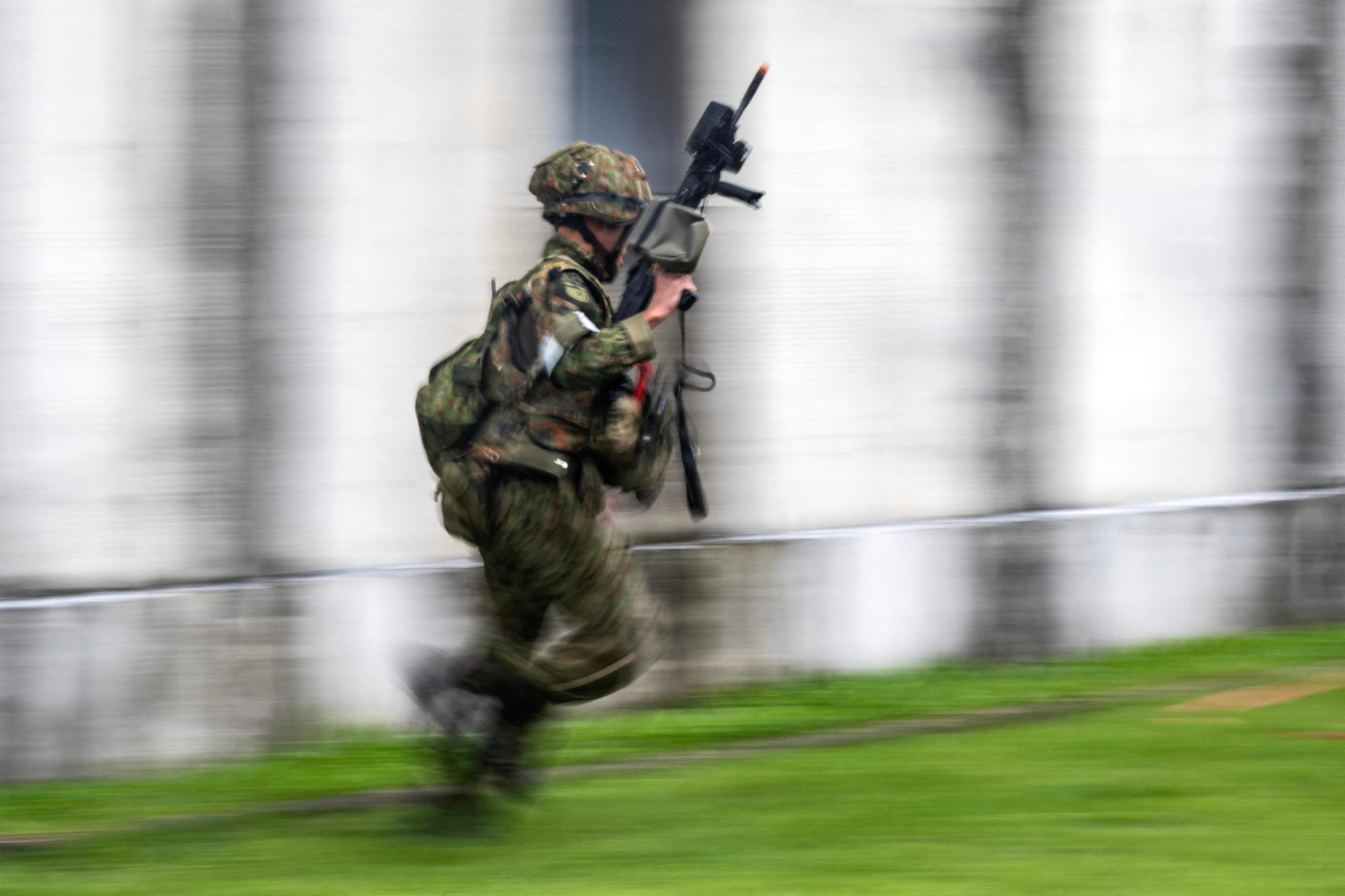 A Japanese soldier runs to a building during an exercise as part of joint drills with France last week. Photo: AFP
