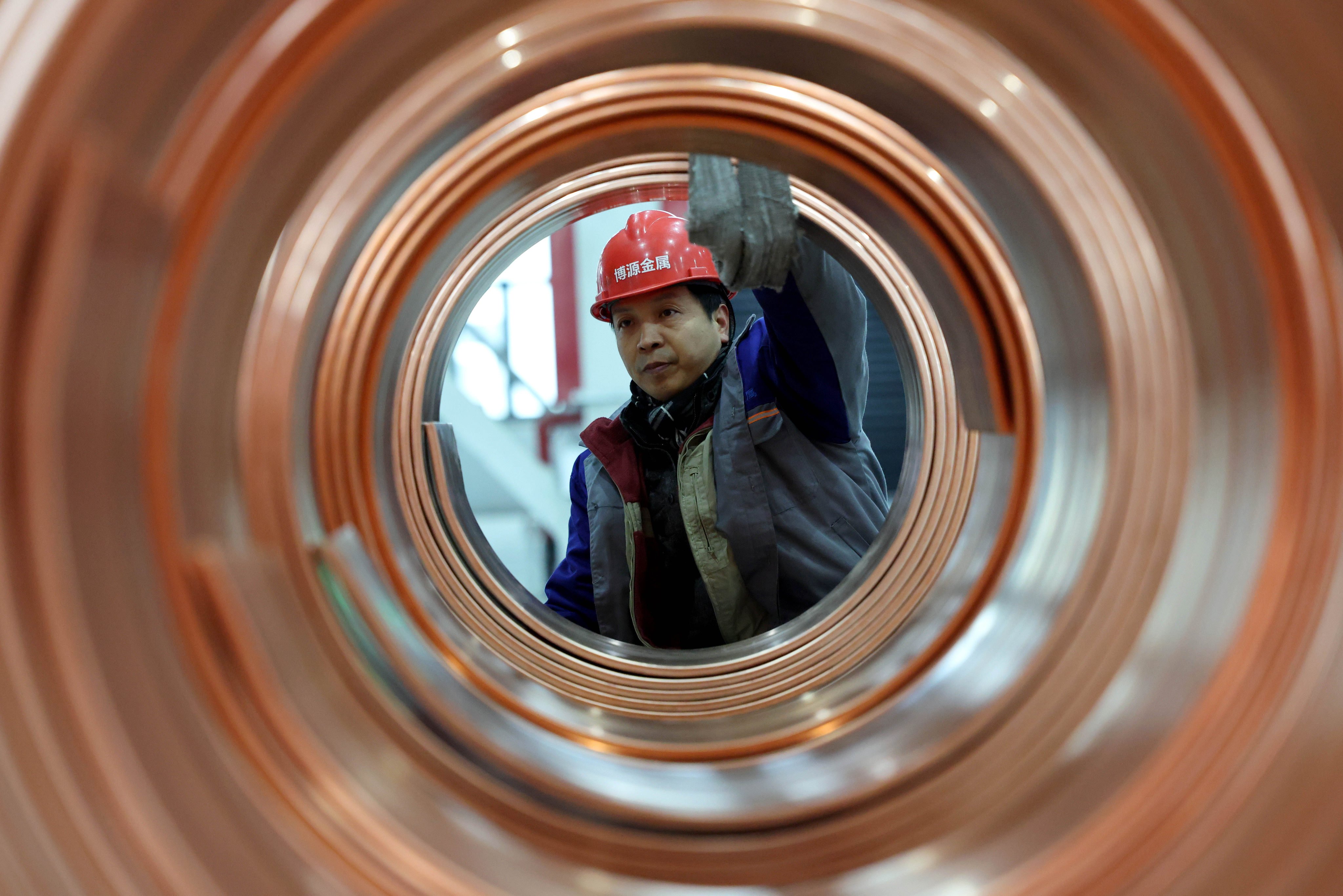 A worker prepares copper rod products for transport at a workshop in China’s Jiangsu province earlier this year. Photo: Xinhua
