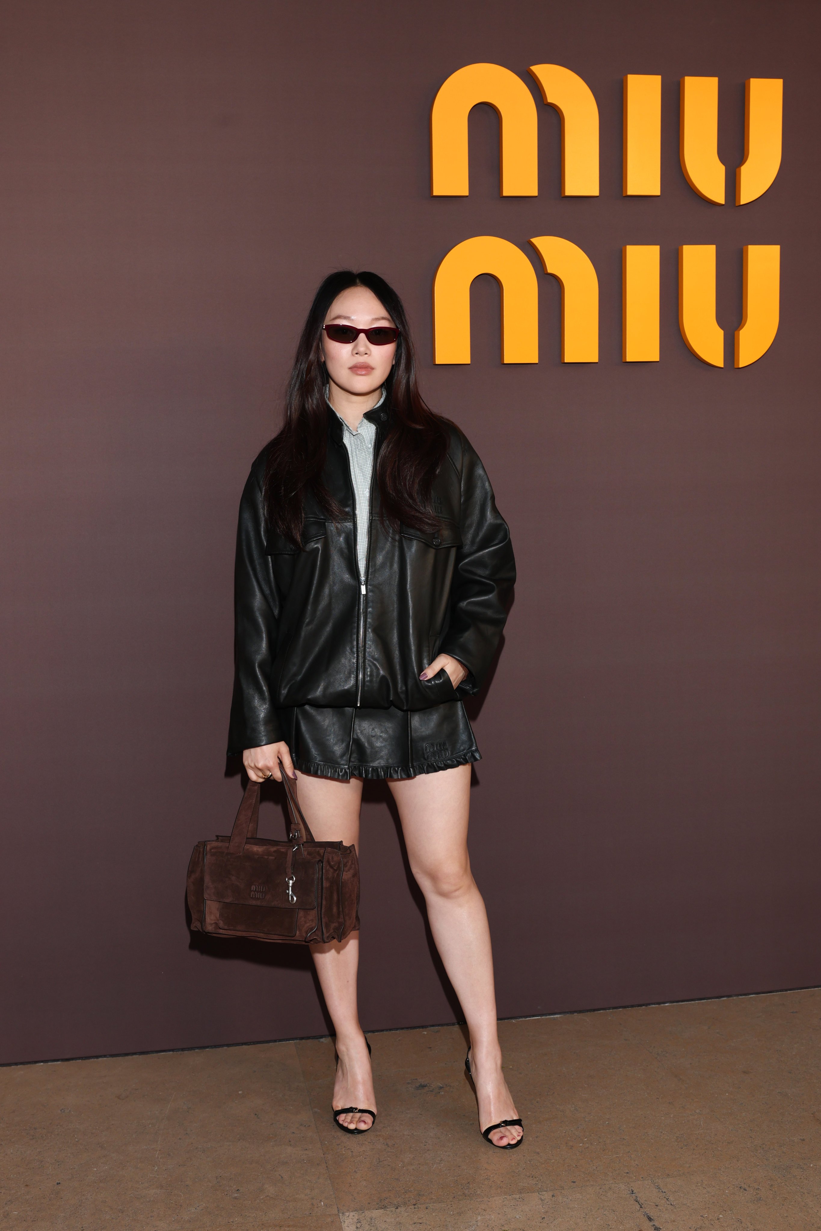 Yerin Ha in a relaxed leather jacket and micro mini skirt at the Miu Miu show at Paris Fashion Week in March. Photo: Getty Images