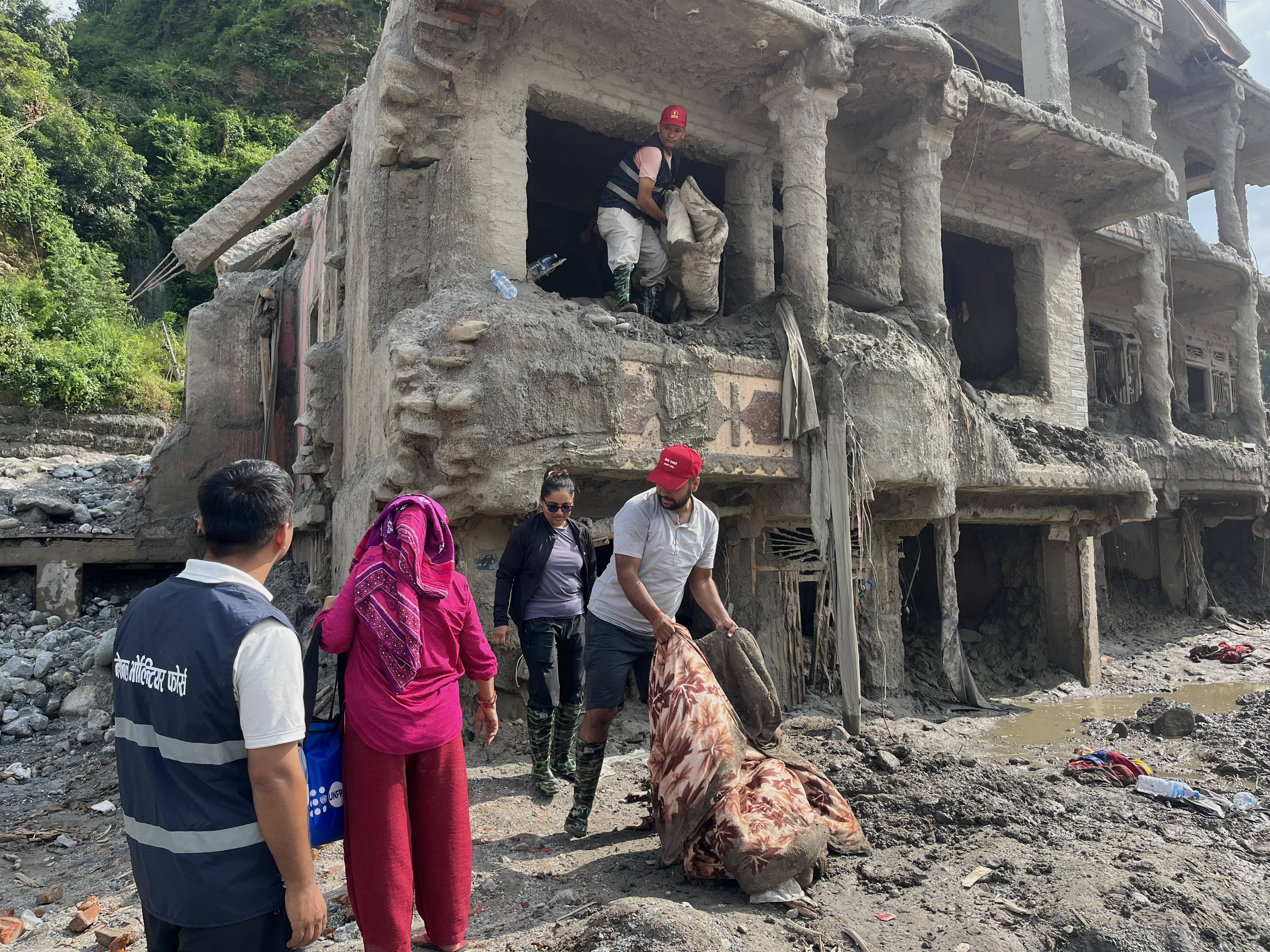 Cleaning up is under way in flood-ravaged houses in Dhunge Bazaar, Nuwakot, Nepal. Photo: Bibek Bhandari
