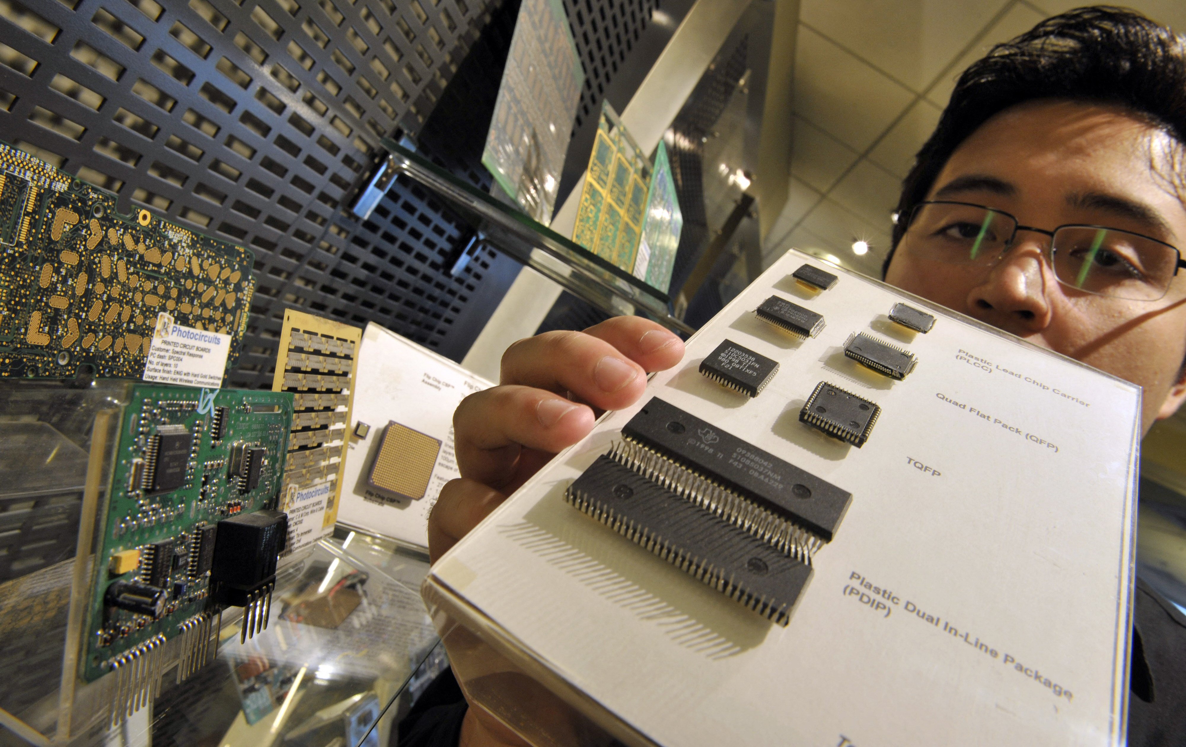 A staff of the Semiconductor and Electronics Industries in the Philippines shows chips manufactured in the country. Photo: AFP