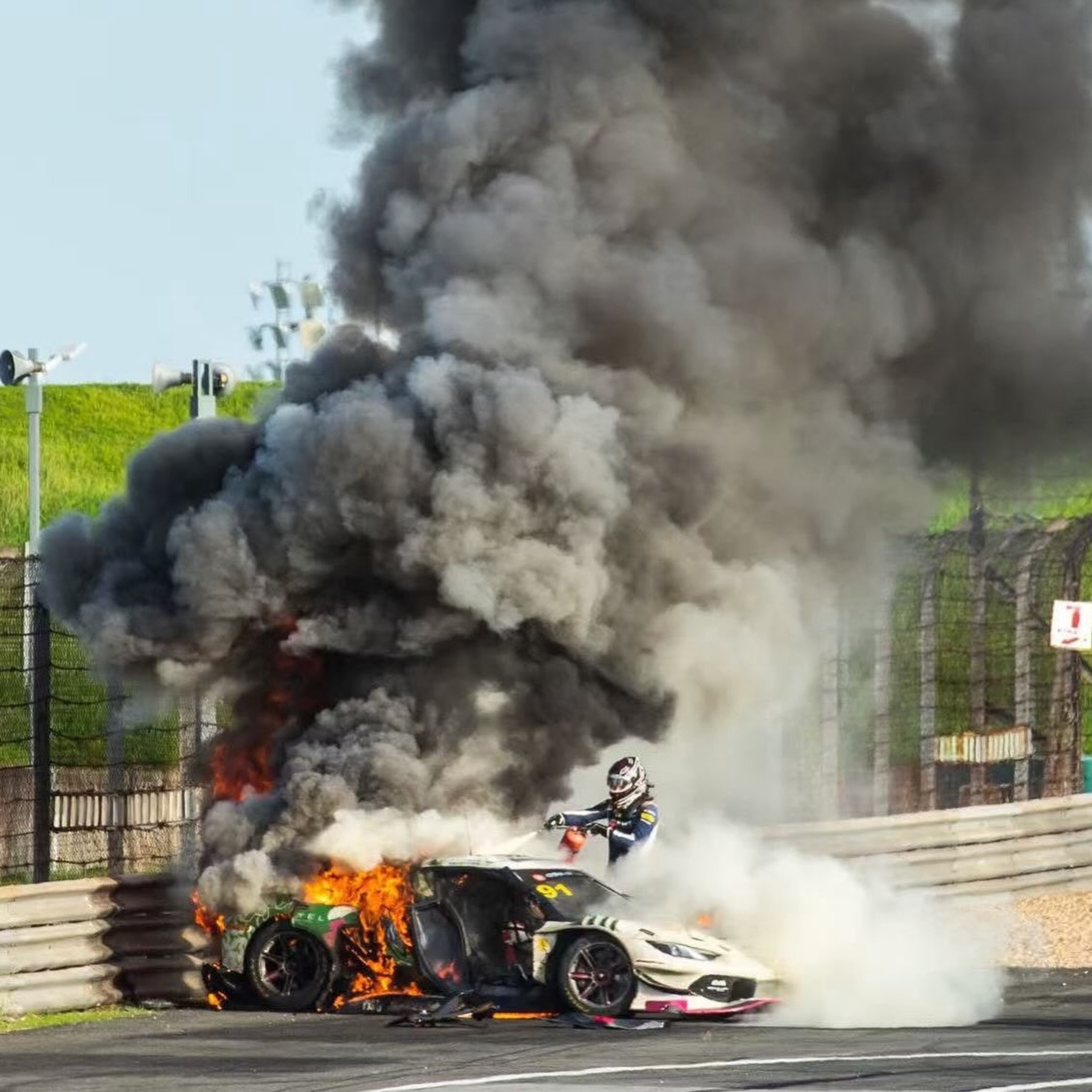 Loek Hartog saves fellow racer Ollie Millroy from a burning car at the China GT. Photo: Instagram/ Ollie Millroy
