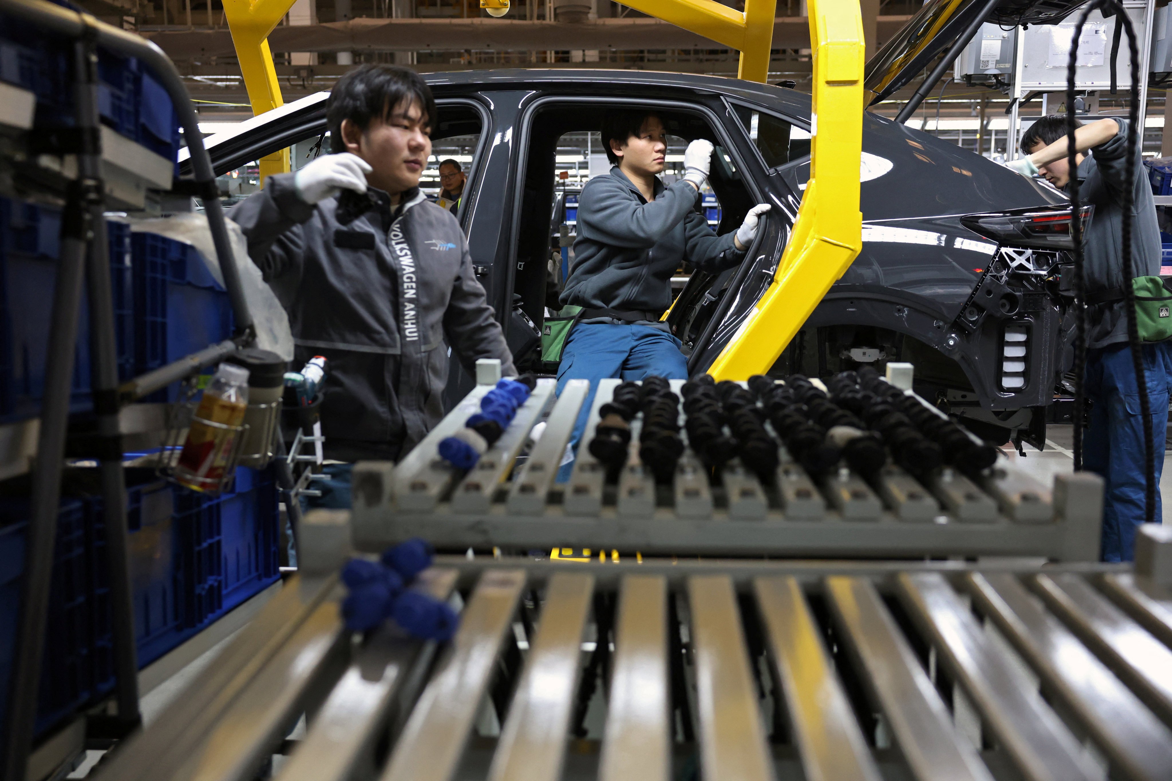 Workers on an electric vehicle production line at the Volkswagen Anhui factory in Hefei, Anhui province. Photo: Reuters