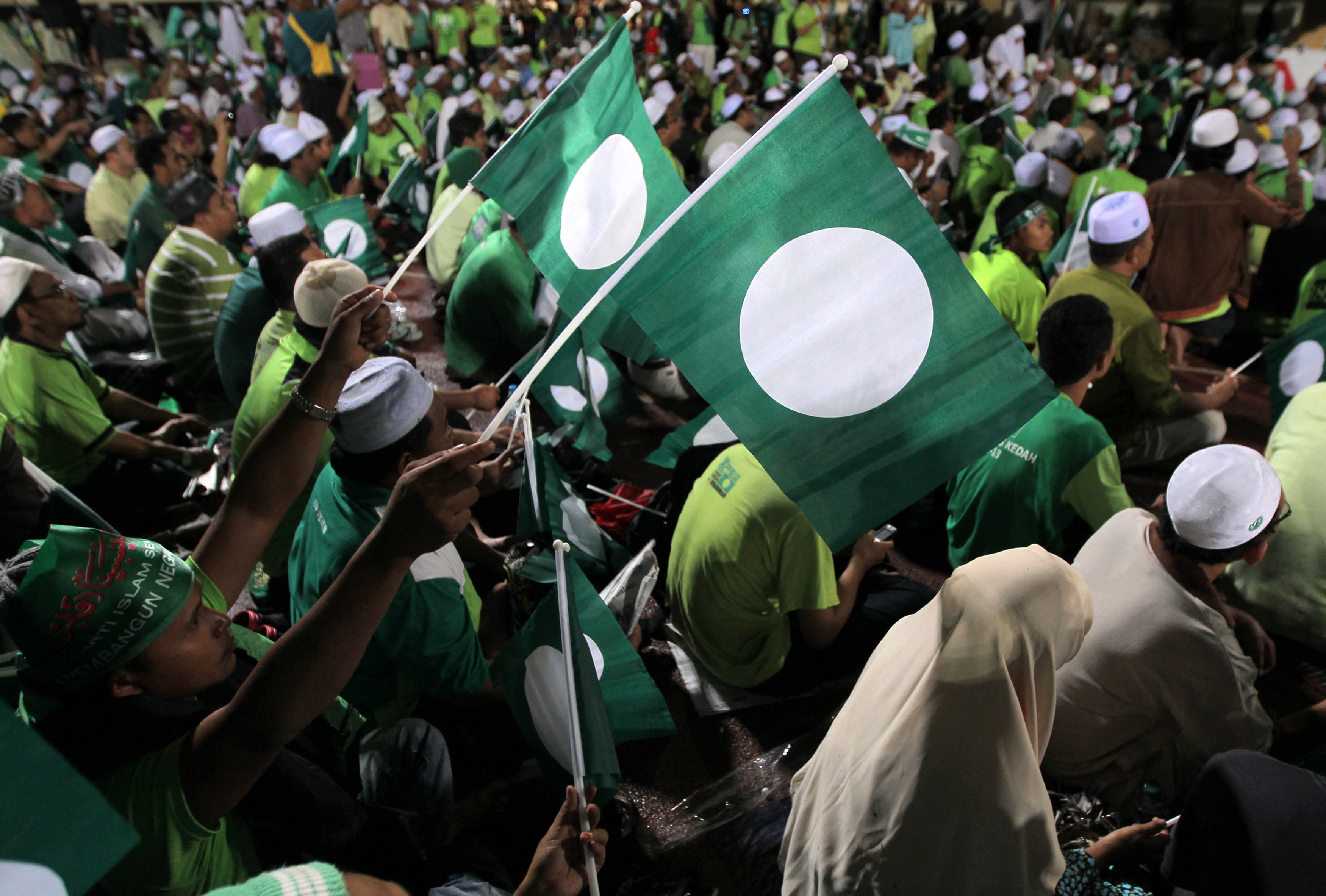 Supporters of the Pan-Malaysian Islamic Party wave flags during a rally in Kedah ahead of the 2012 general election. Photo: AFP