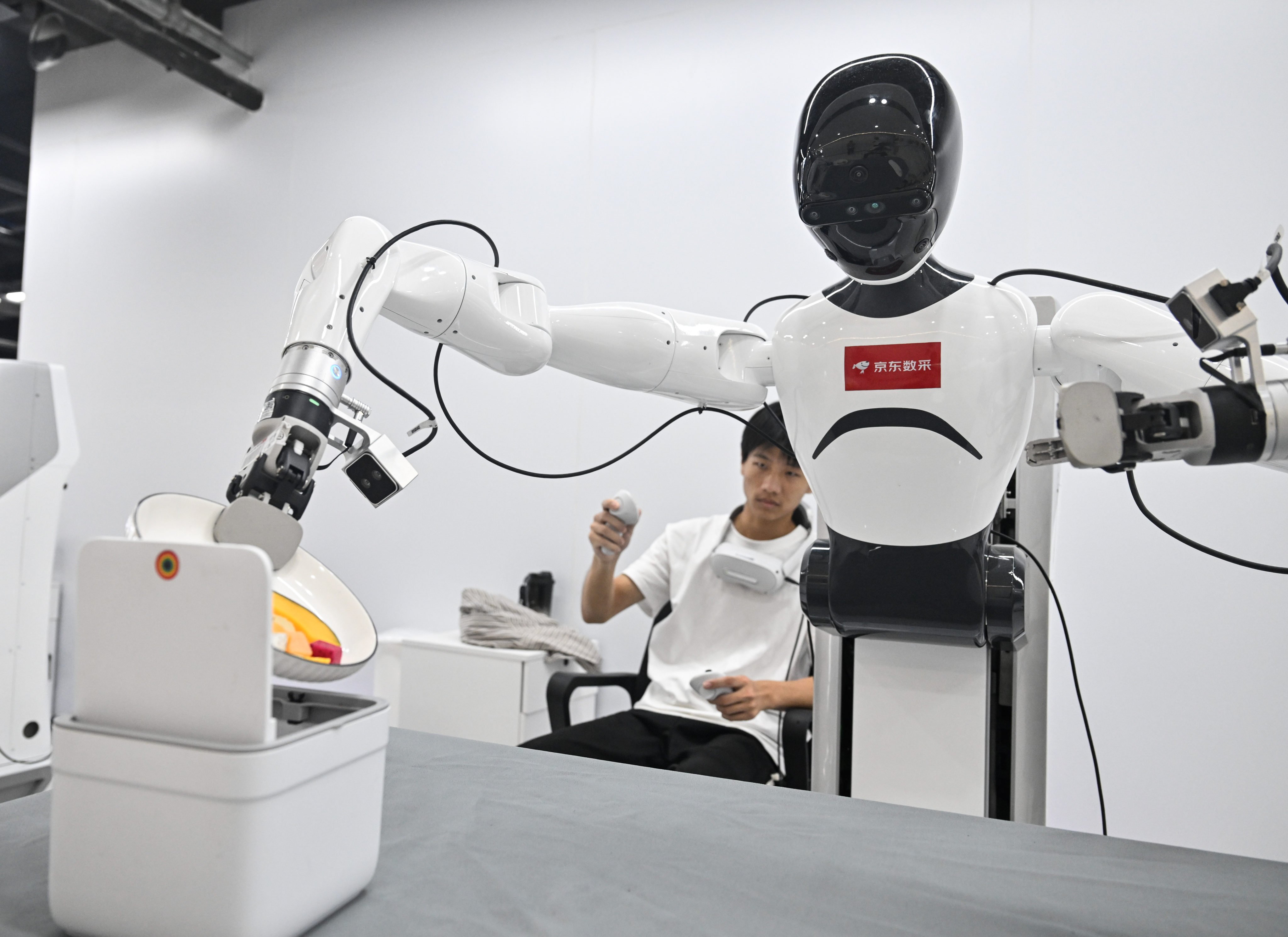 A technician trains a robot at a JD.com data collection centre in eastern China’s Jiangsu province on August 24. Photo: Xinhua