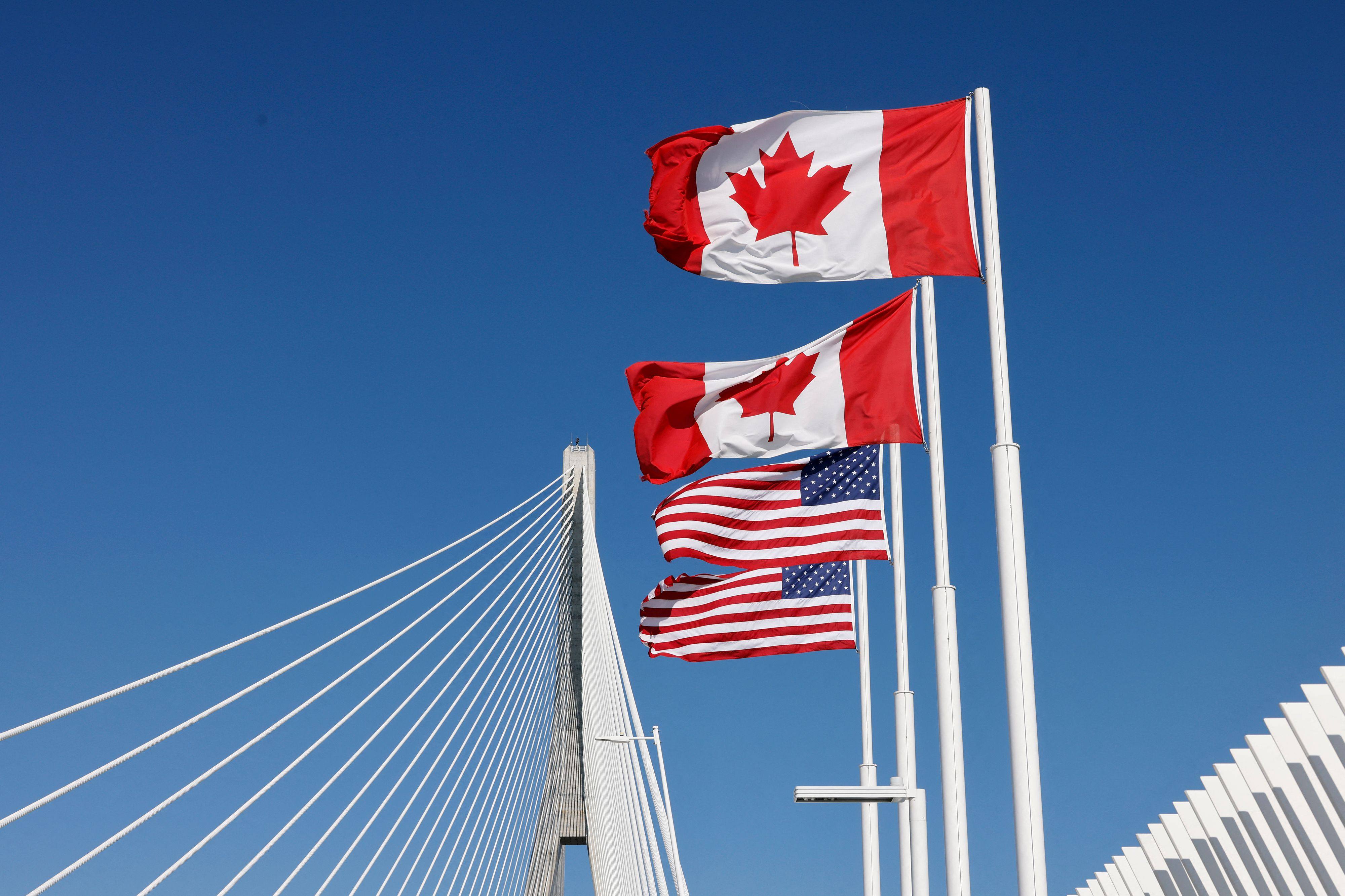 Canadian and US flags fly across the international border on the Gordie Howe International bridge that connects Windsor, Ontario,  and Detroit, Michigan. Photo: AFP