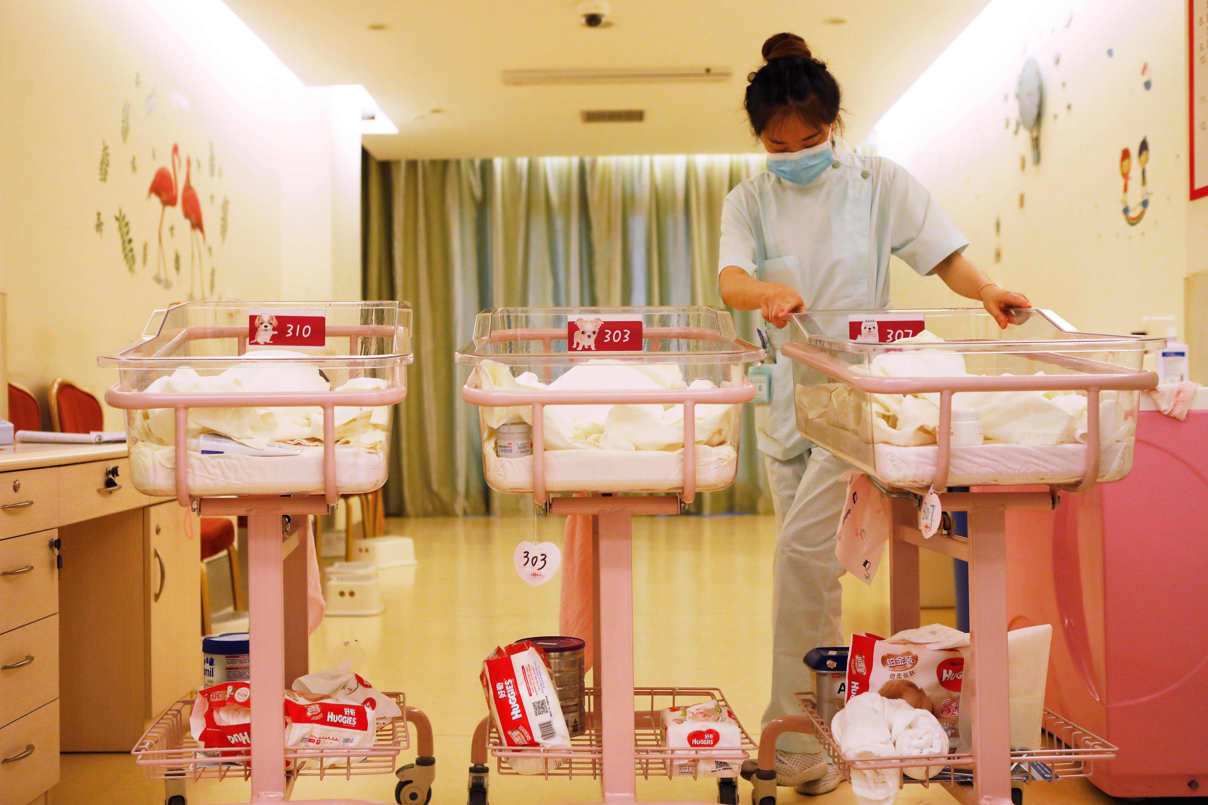 A staff member cares for newborn babies at a postpartum care centre in Shanghai. Photo: AFP