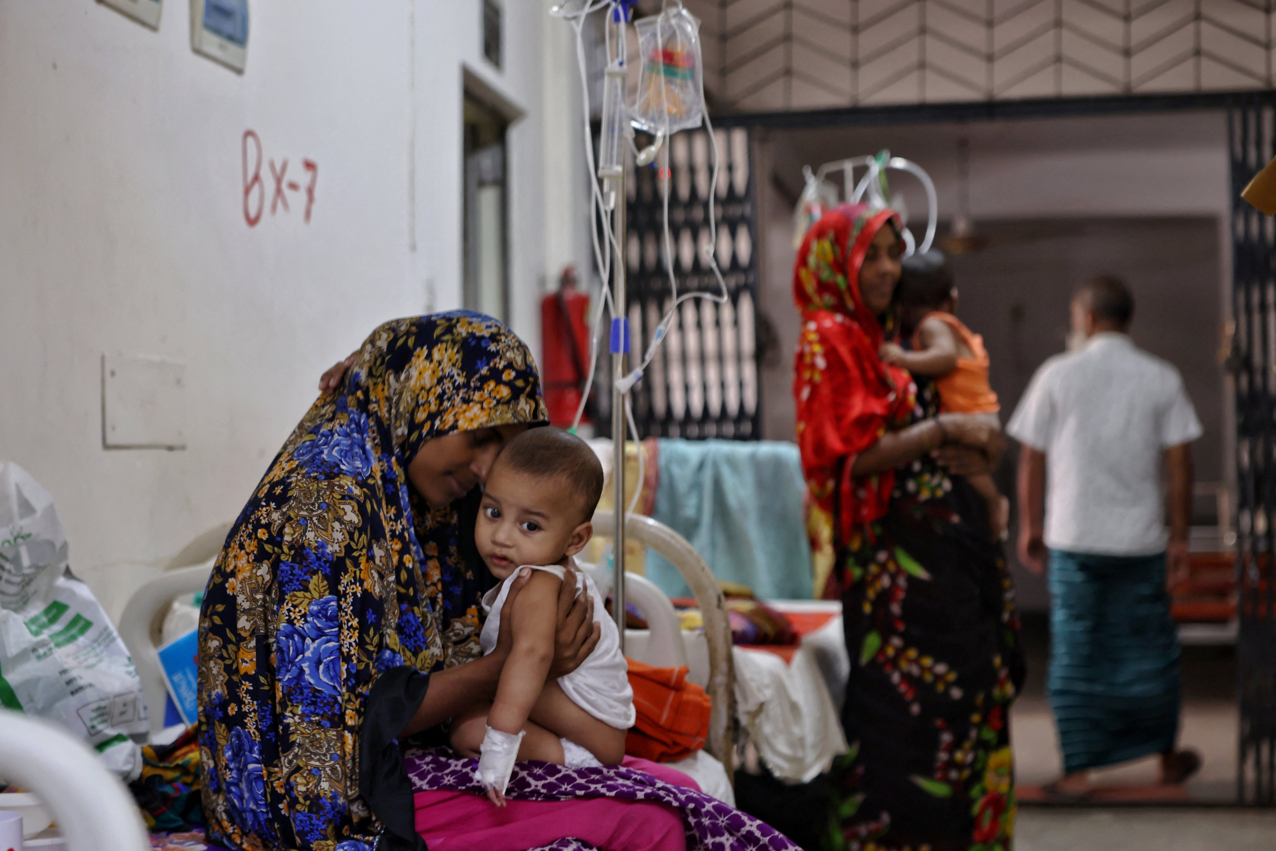 A woman cuddles her nine-month-old son, who suffers from measles and receives treatment at the Infectious Diseases Hospital in Dhaka, Bangladesh, on Wednesday. Photo: Reuters