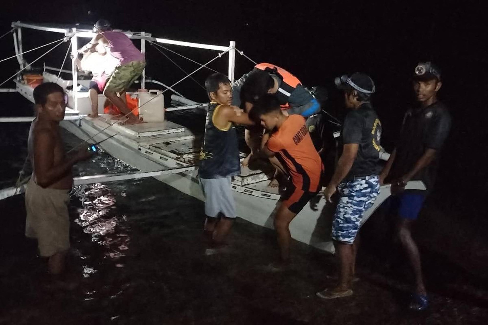 Volunteer fisherfolk help the survivors from the ferry that caught fire off Palawan, Philippines, on Wednesday. Photo: PCG/AFP
