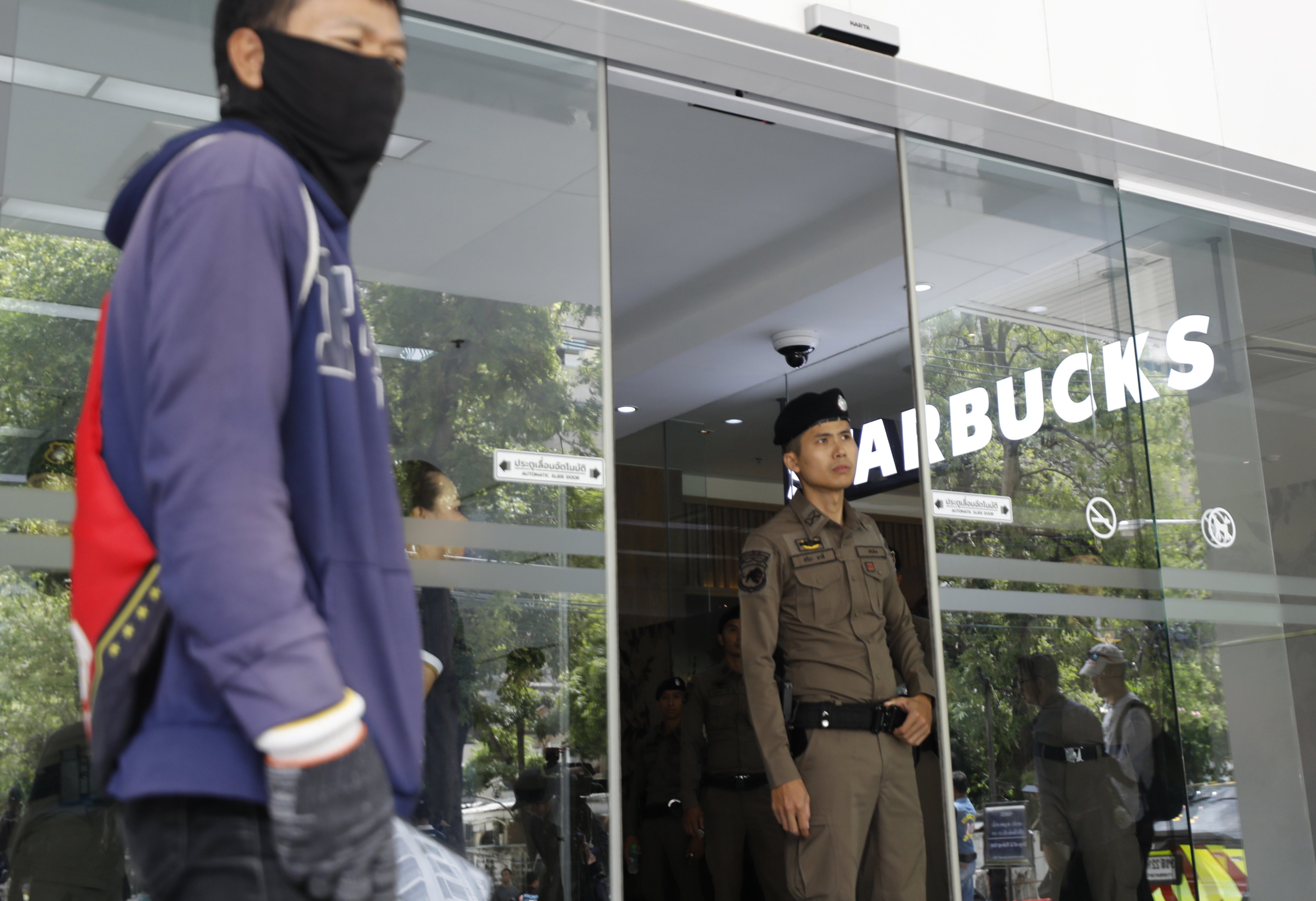 A police officer guards the entrance of a building housing the Israeli Embassy during a rally in Bangkok on Thursday. Photo: EPA