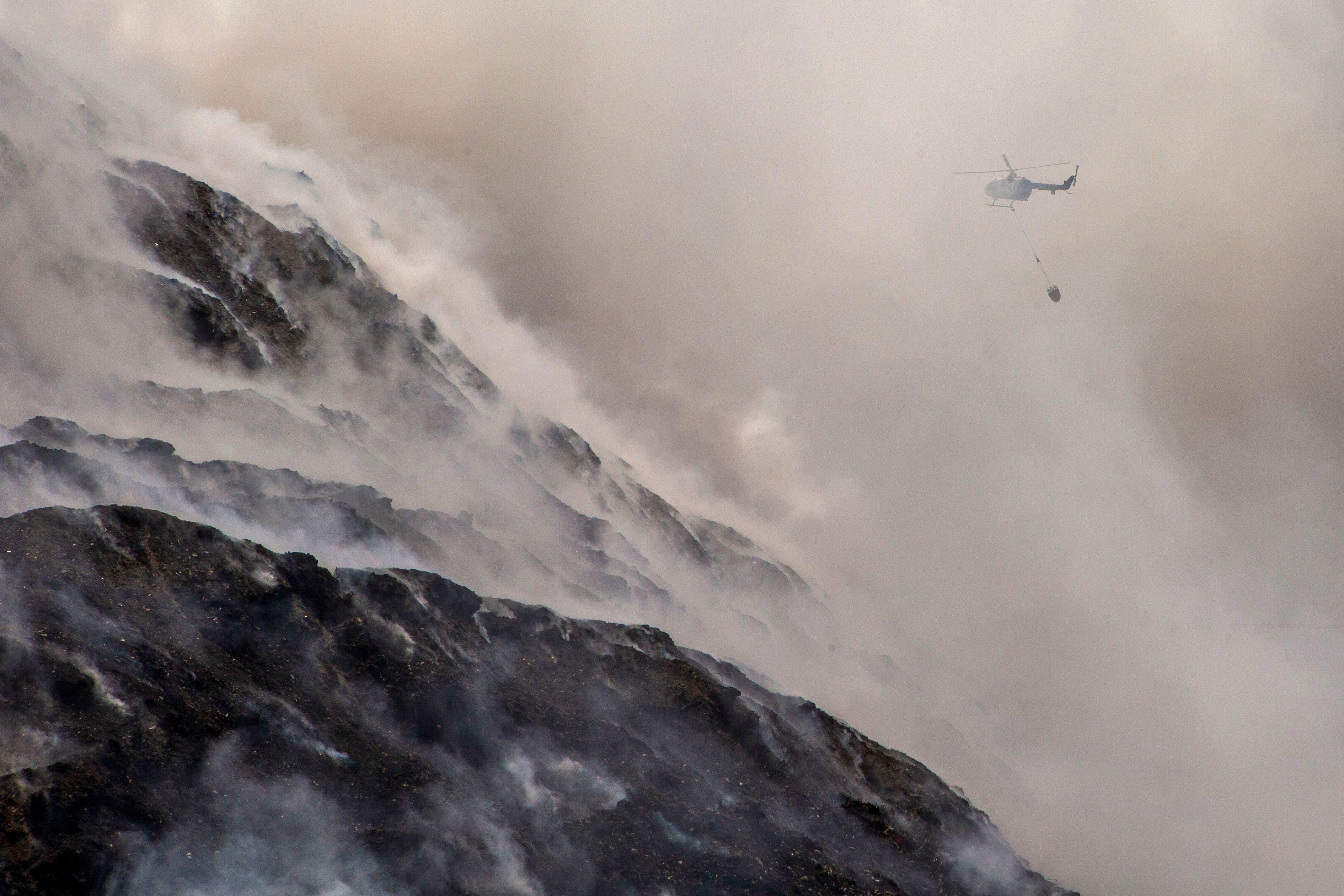 A helicopter drops water on a wildfire in Central Java, Indonesia on Friday. Photo: AFP