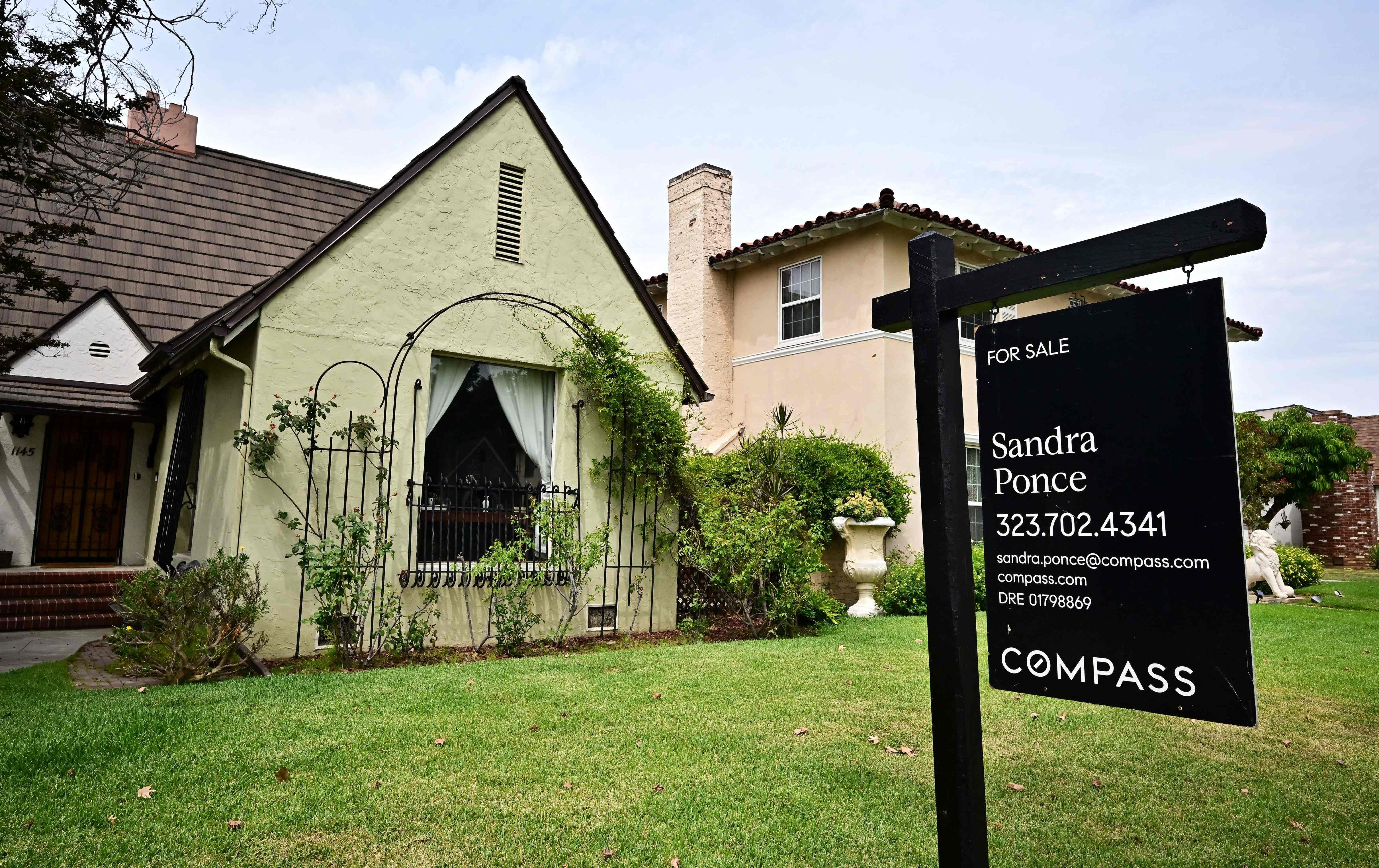 A “For Sale” sign is posted beside property for sale in Alhambra, California. Photo: AFP