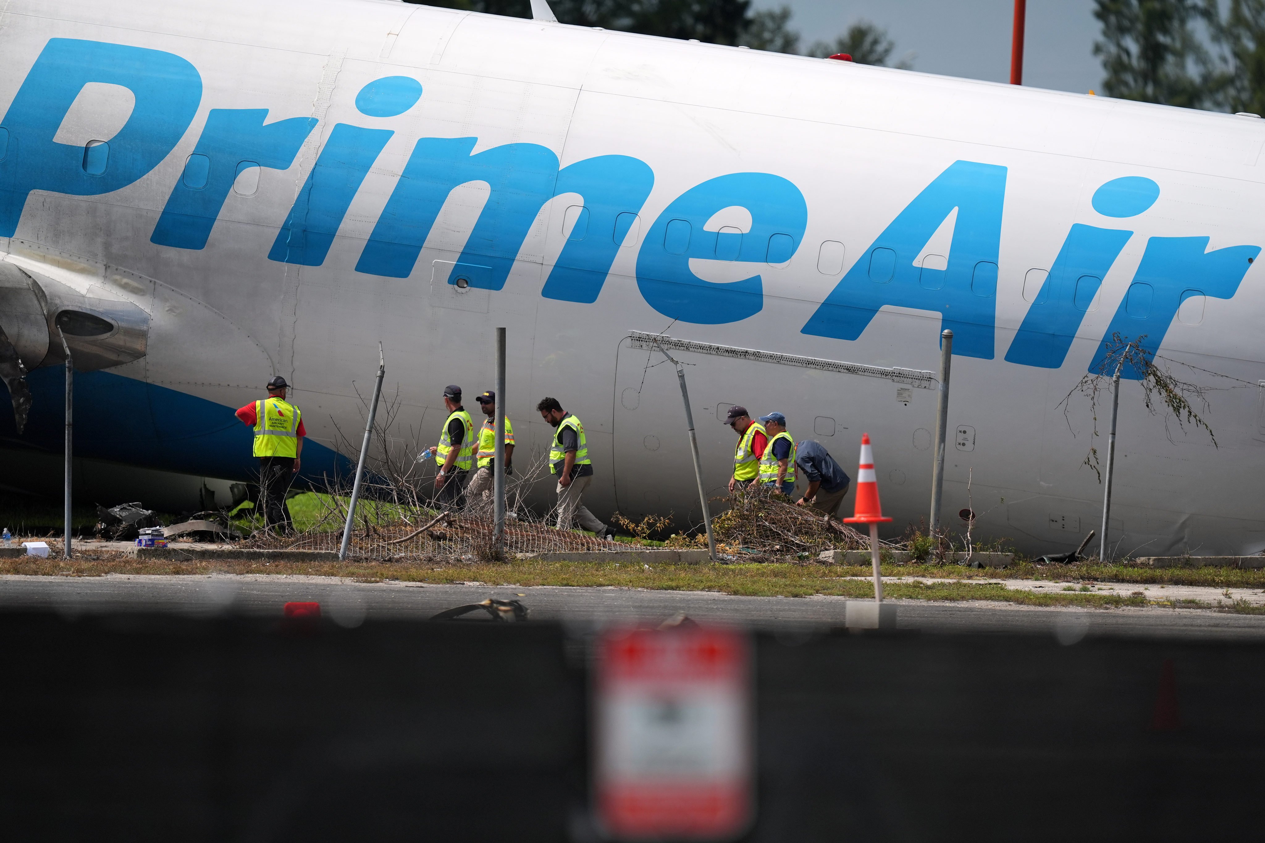 Workers inspect the wreckage. Photo: AP